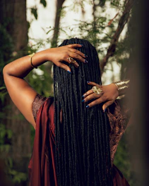 Woman with long braided hair in a forest