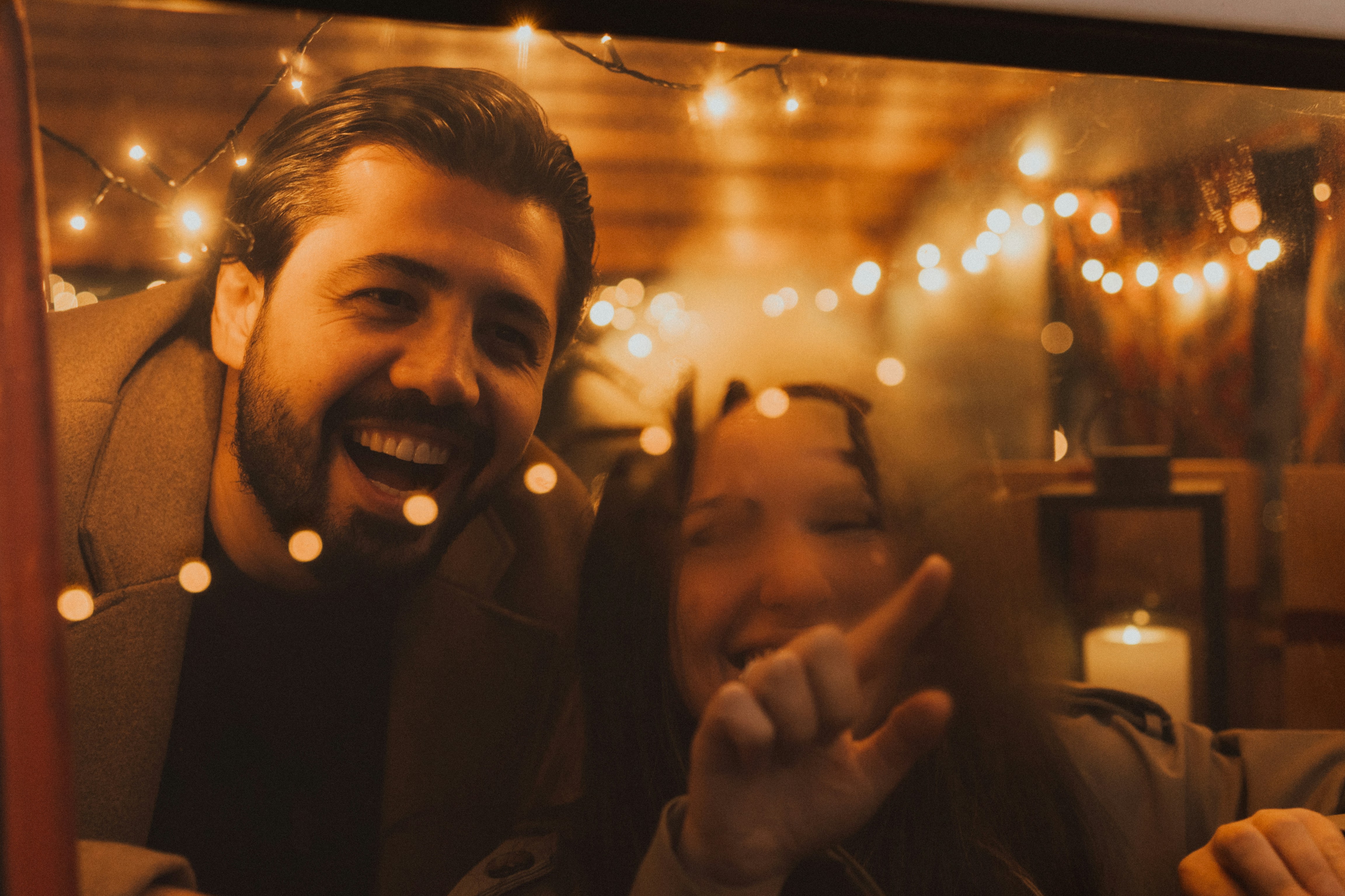 Man and child laughing with fairy lights