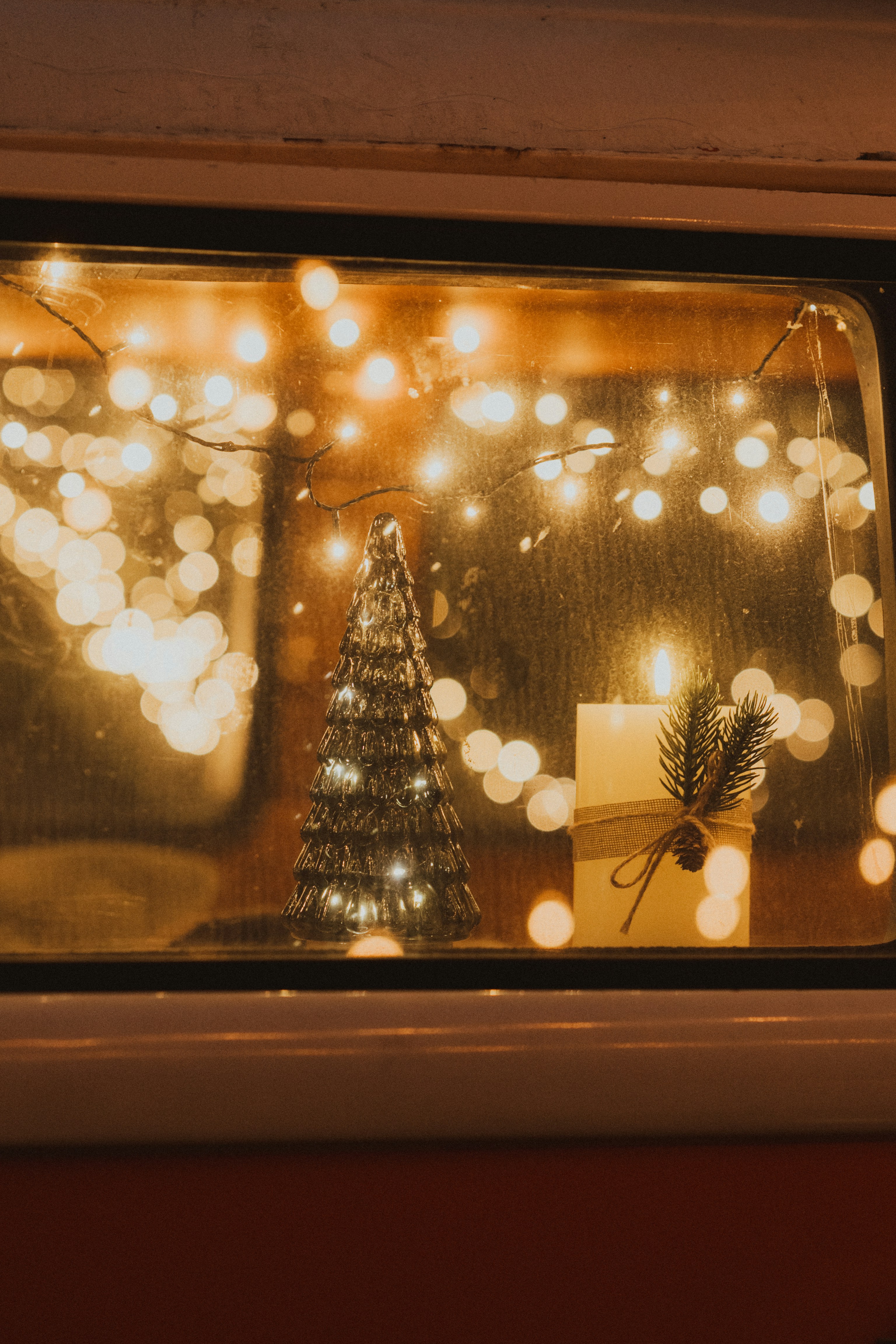Christmas tree and candle with bokeh lights
