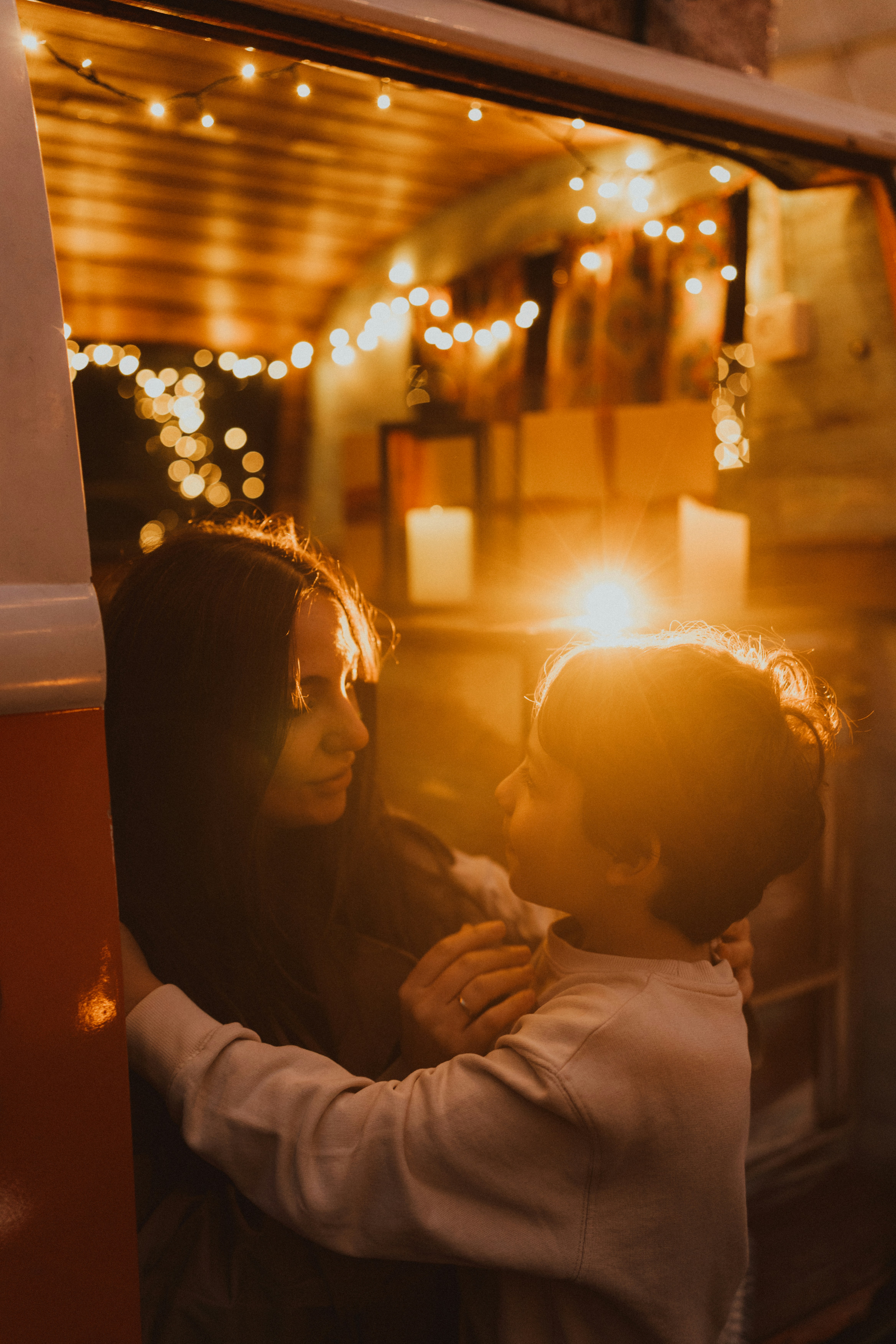 Woman and child embracing with warm lights