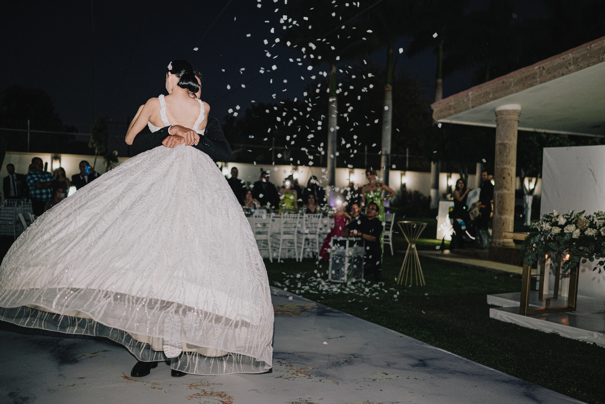 Black and white photo of a bride celebrating with guests