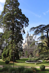 Grand building with trees and fountain in park