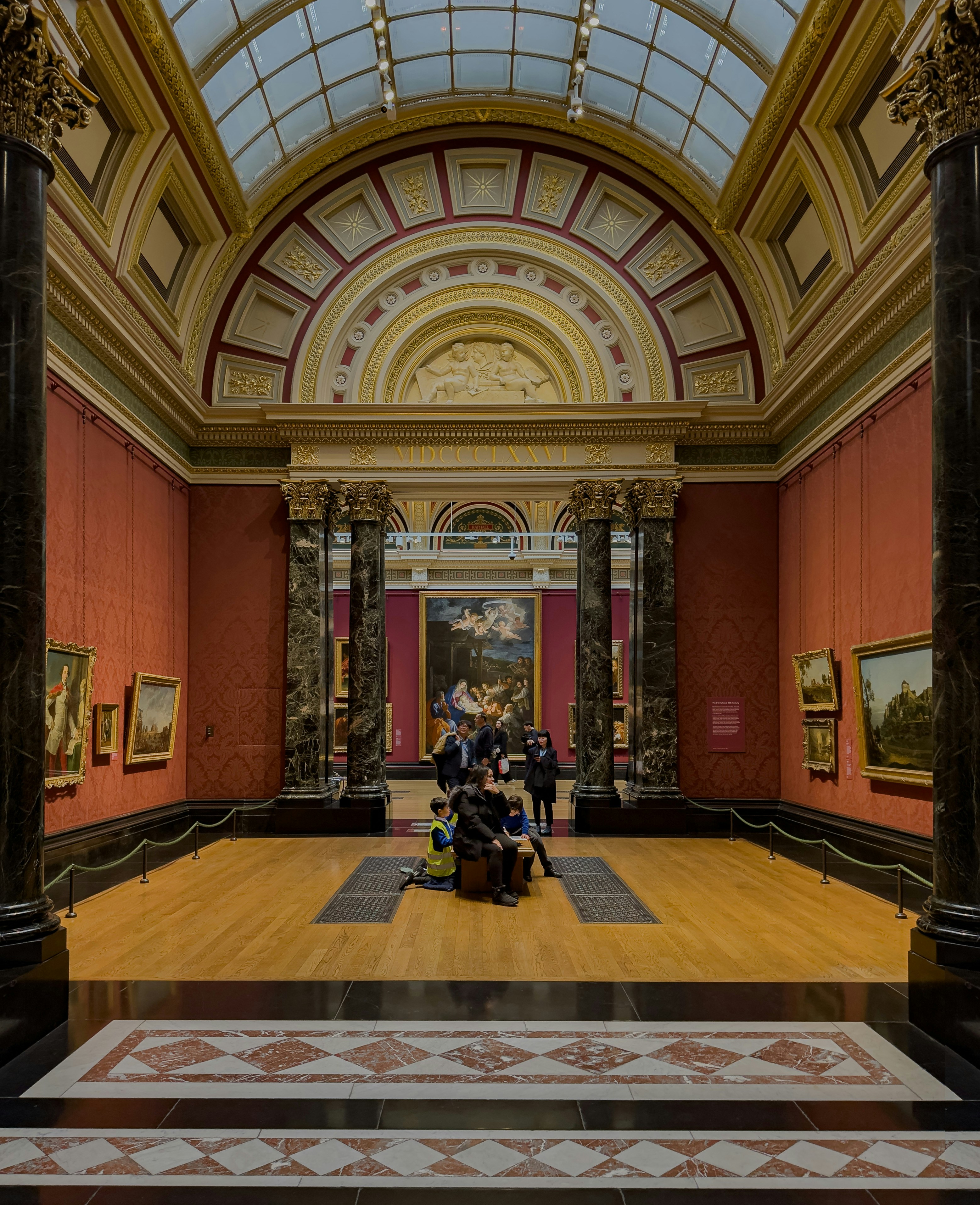 People viewing art in a grand museum gallery