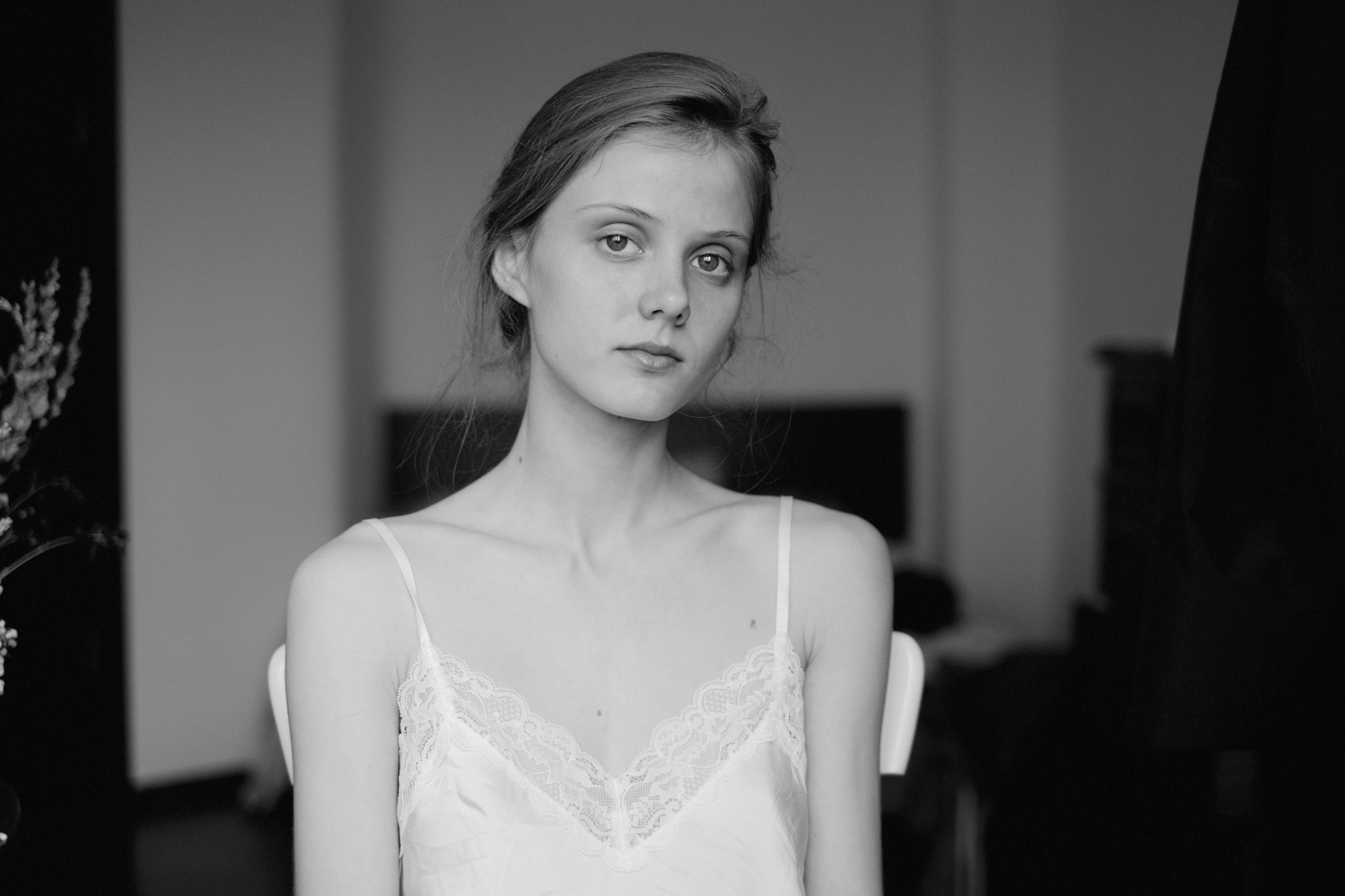 Young woman with light hair wearing a slip