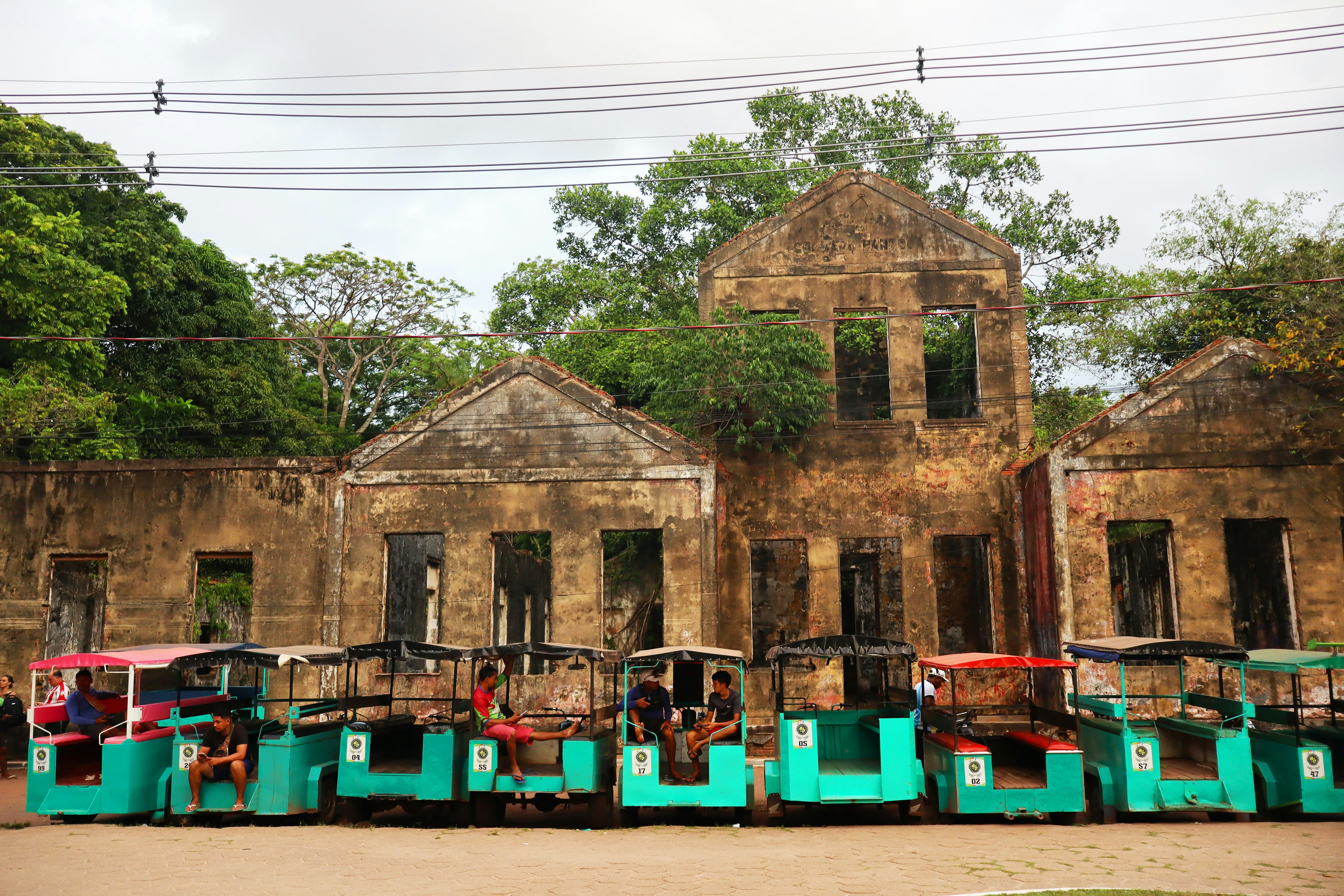 Old stone buildings with teal carts lined up