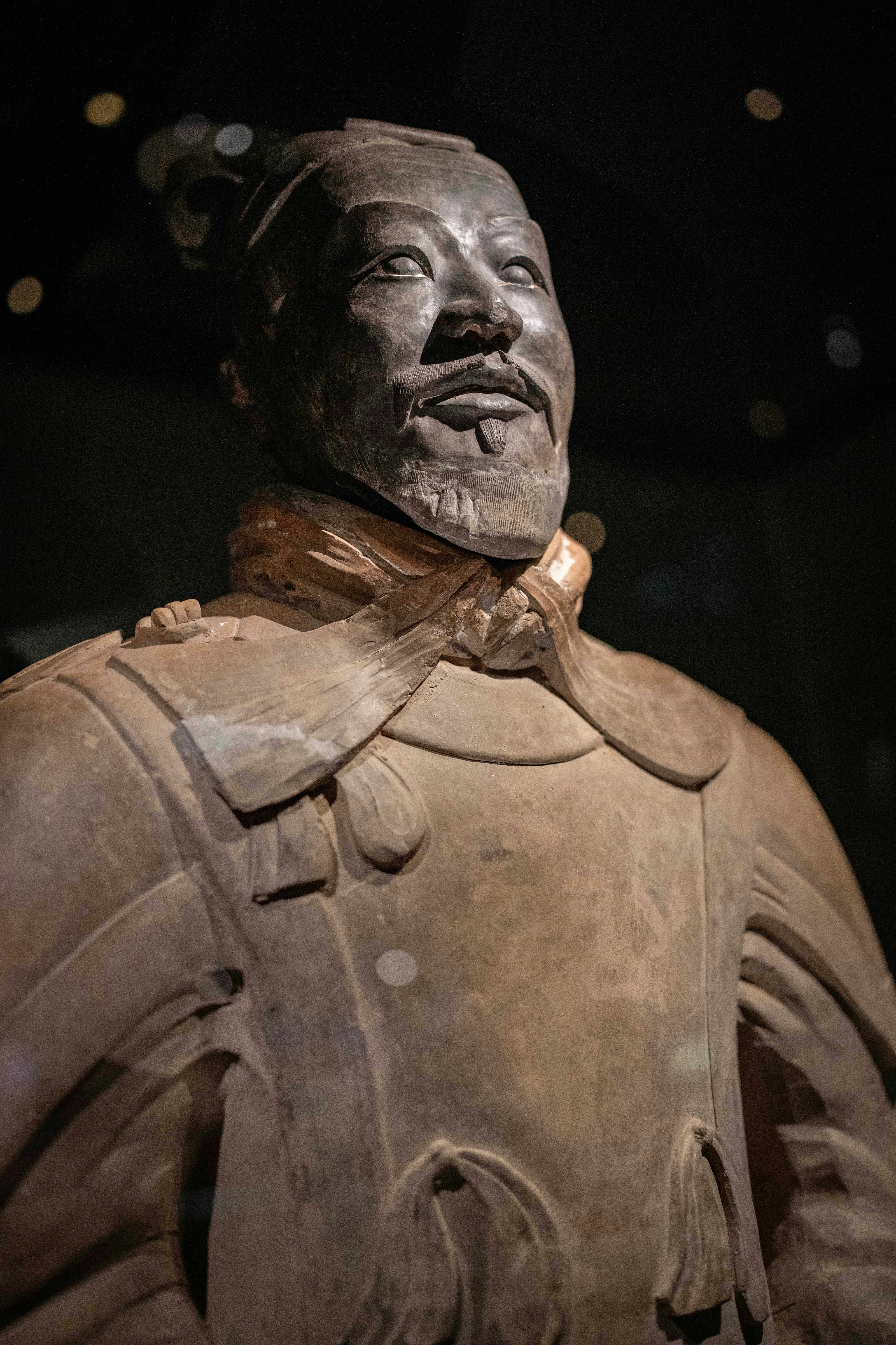 Terracotta warrior statue with detailed armor and headdress