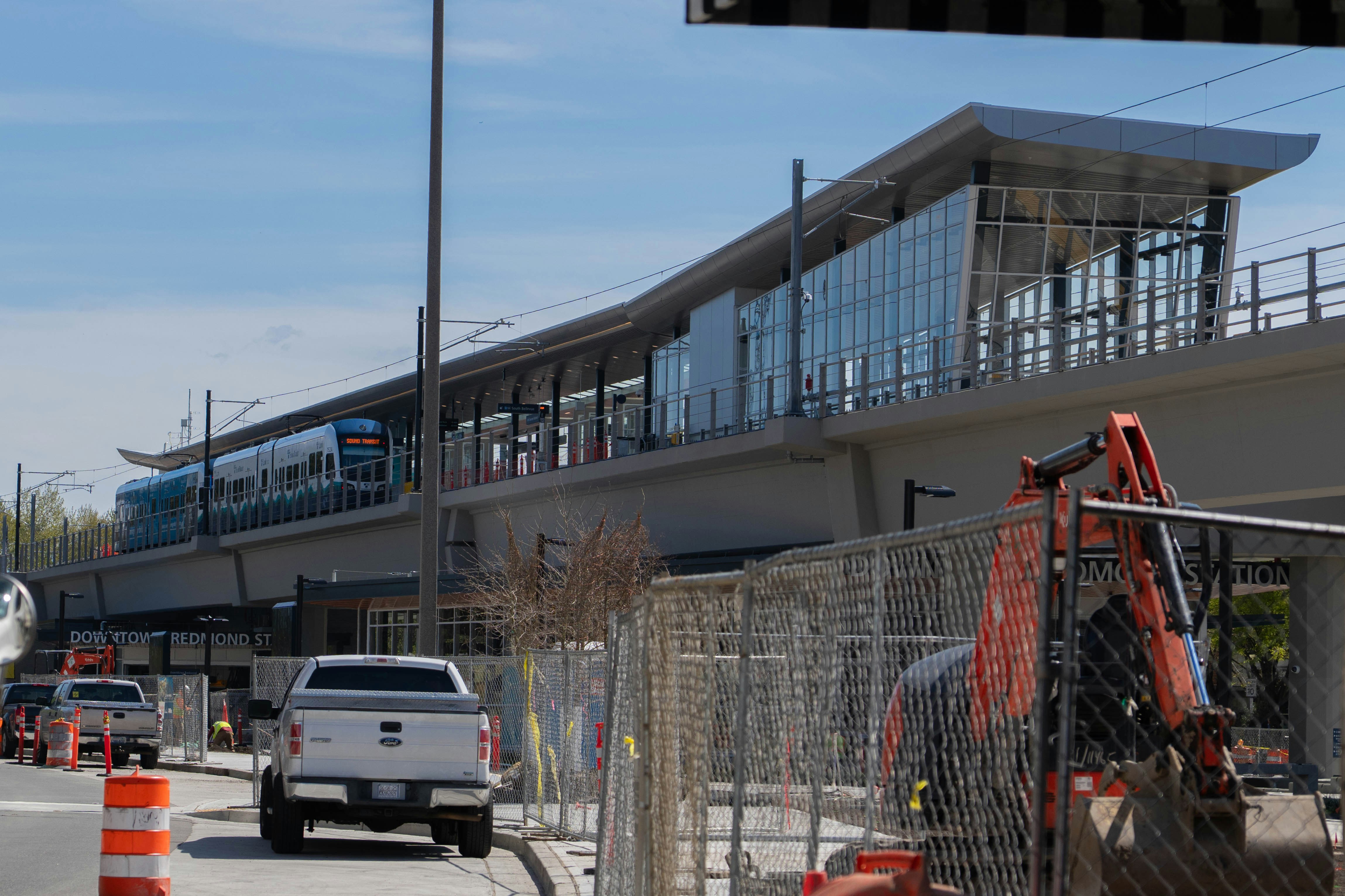Modern train station under construction with train.