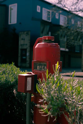 Red fire hydrant with an open sign.