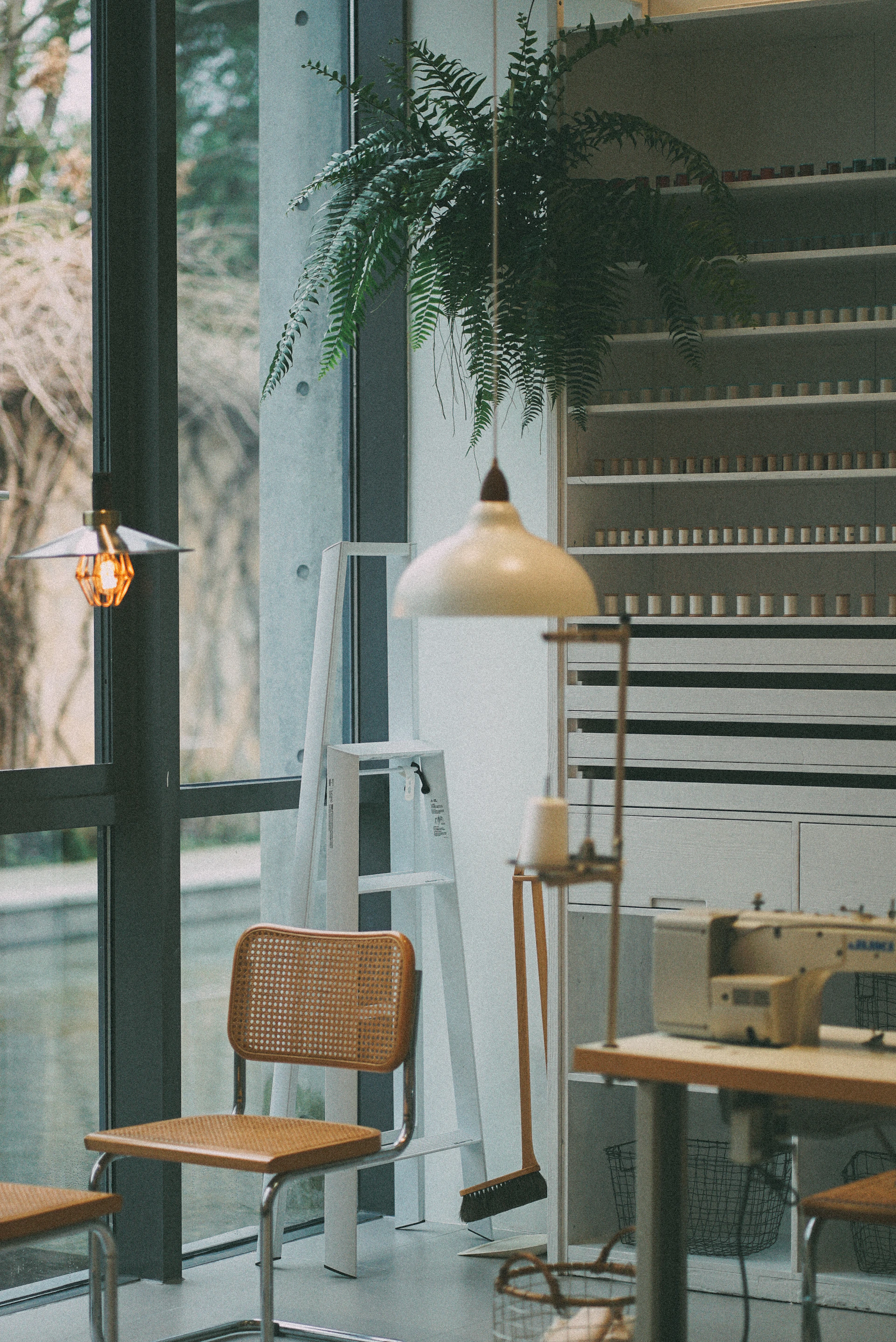 A bright room with a sewing machine and chair.