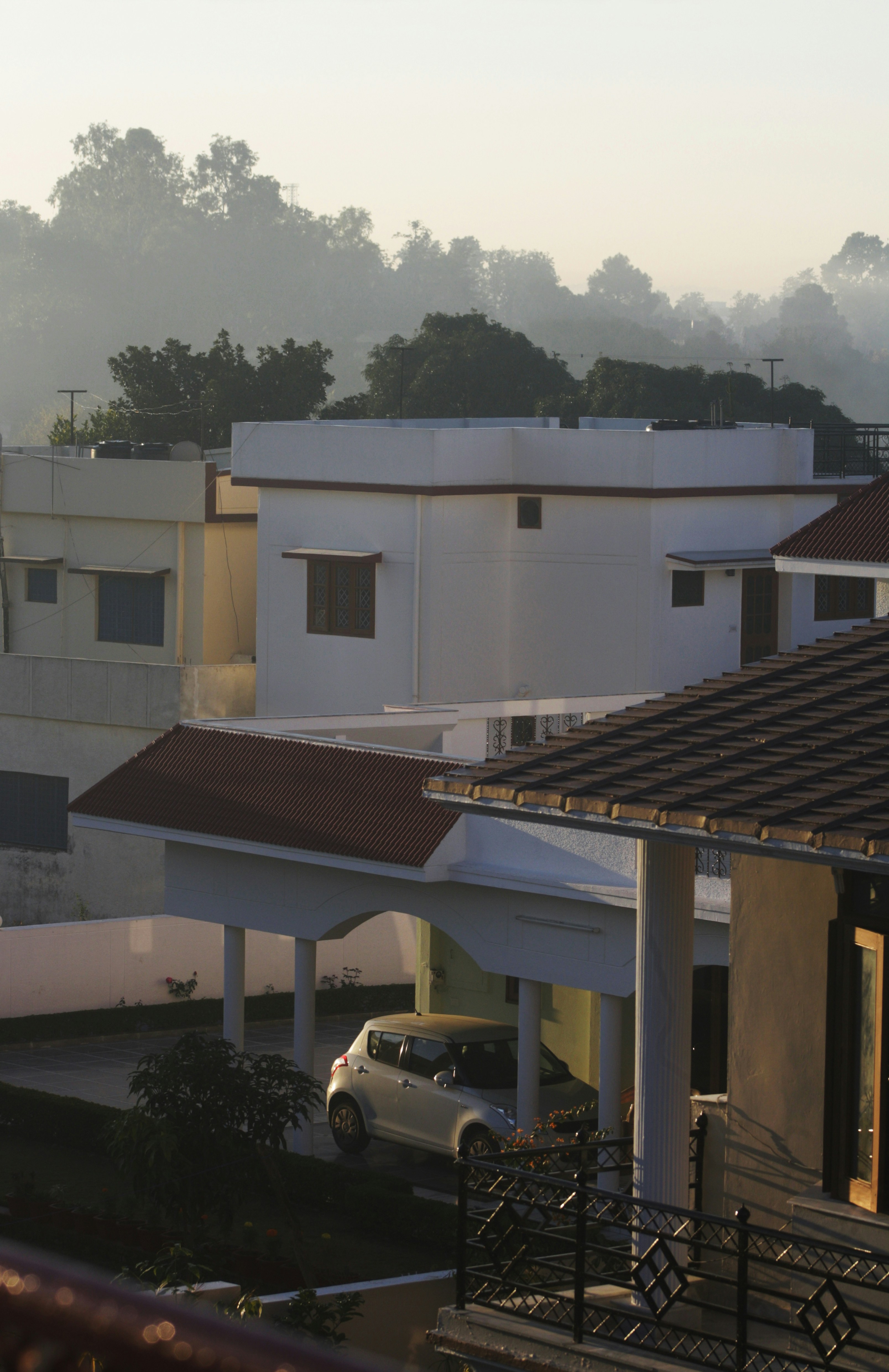 White modern houses with a car parked outside.