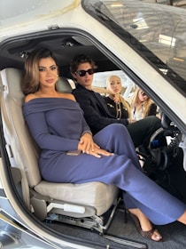 Four people sitting inside a small aircraft