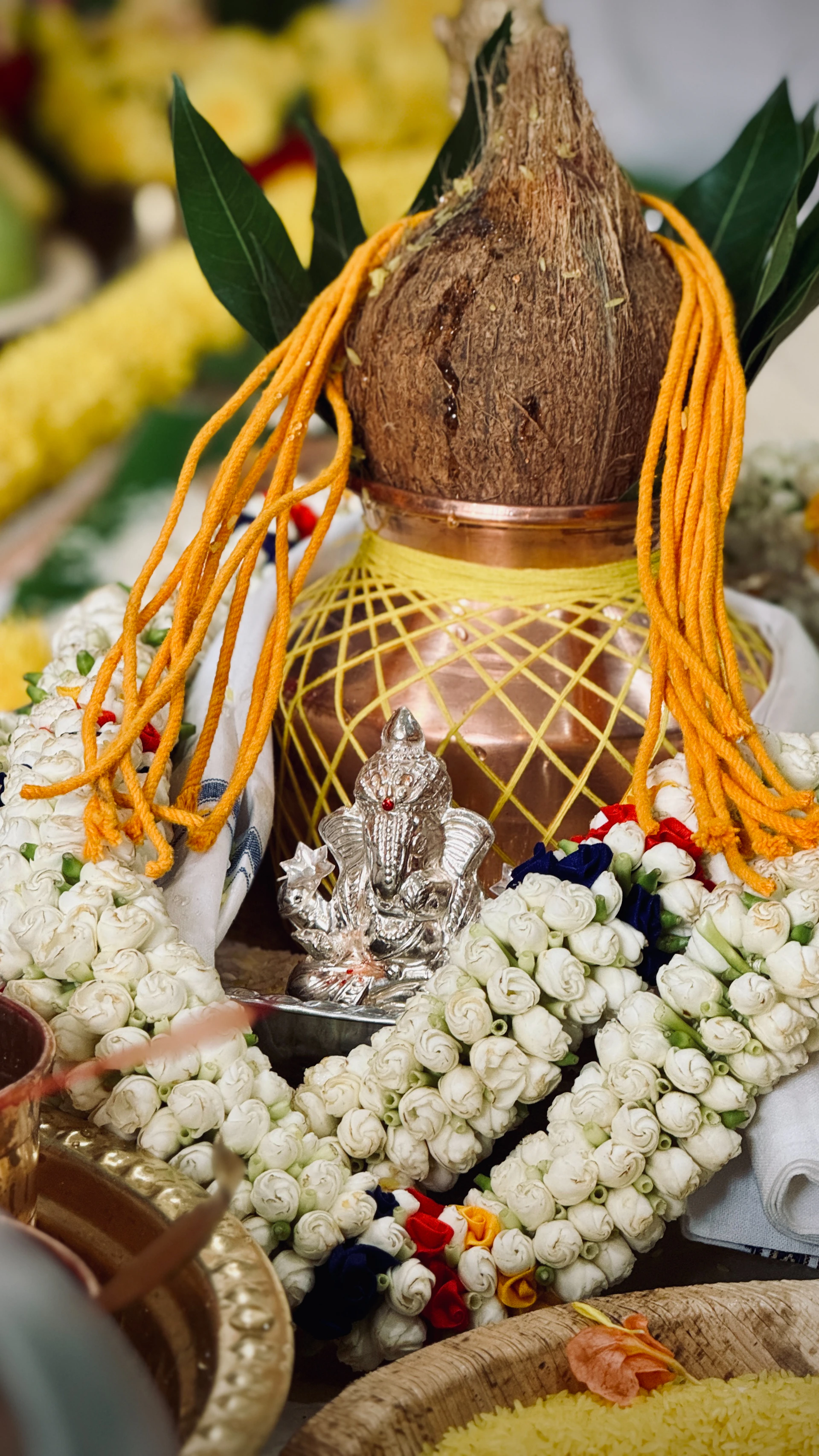 A religious offering with a coconut and ganesha idol.