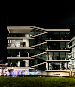 Modern office building at night with illuminated windows