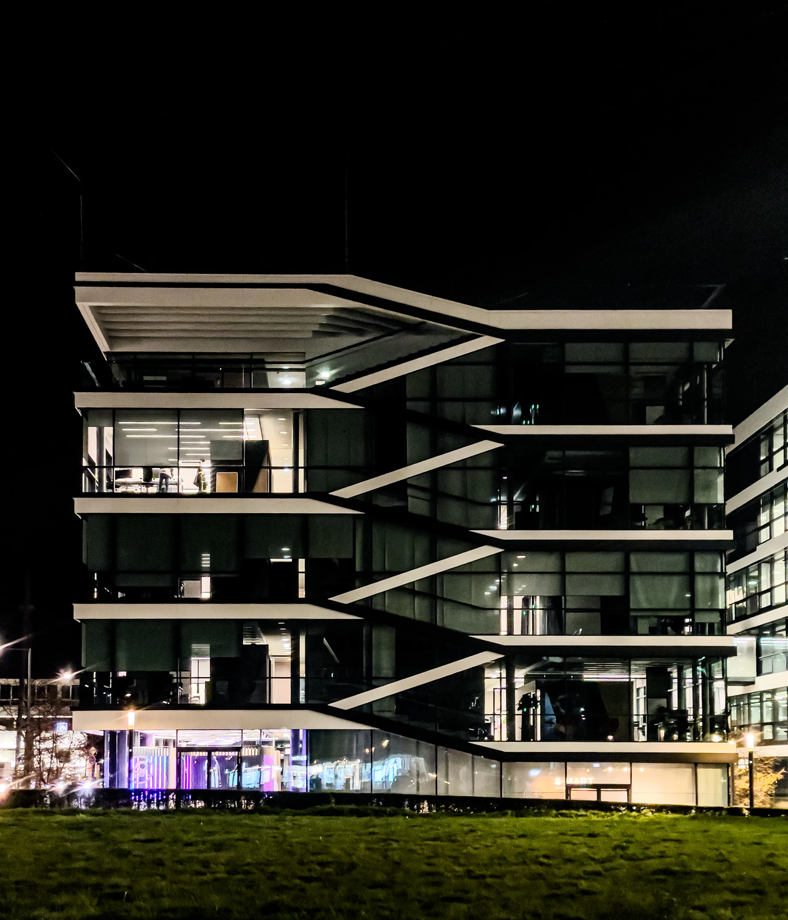Modern corporate headquarters illuminated at night