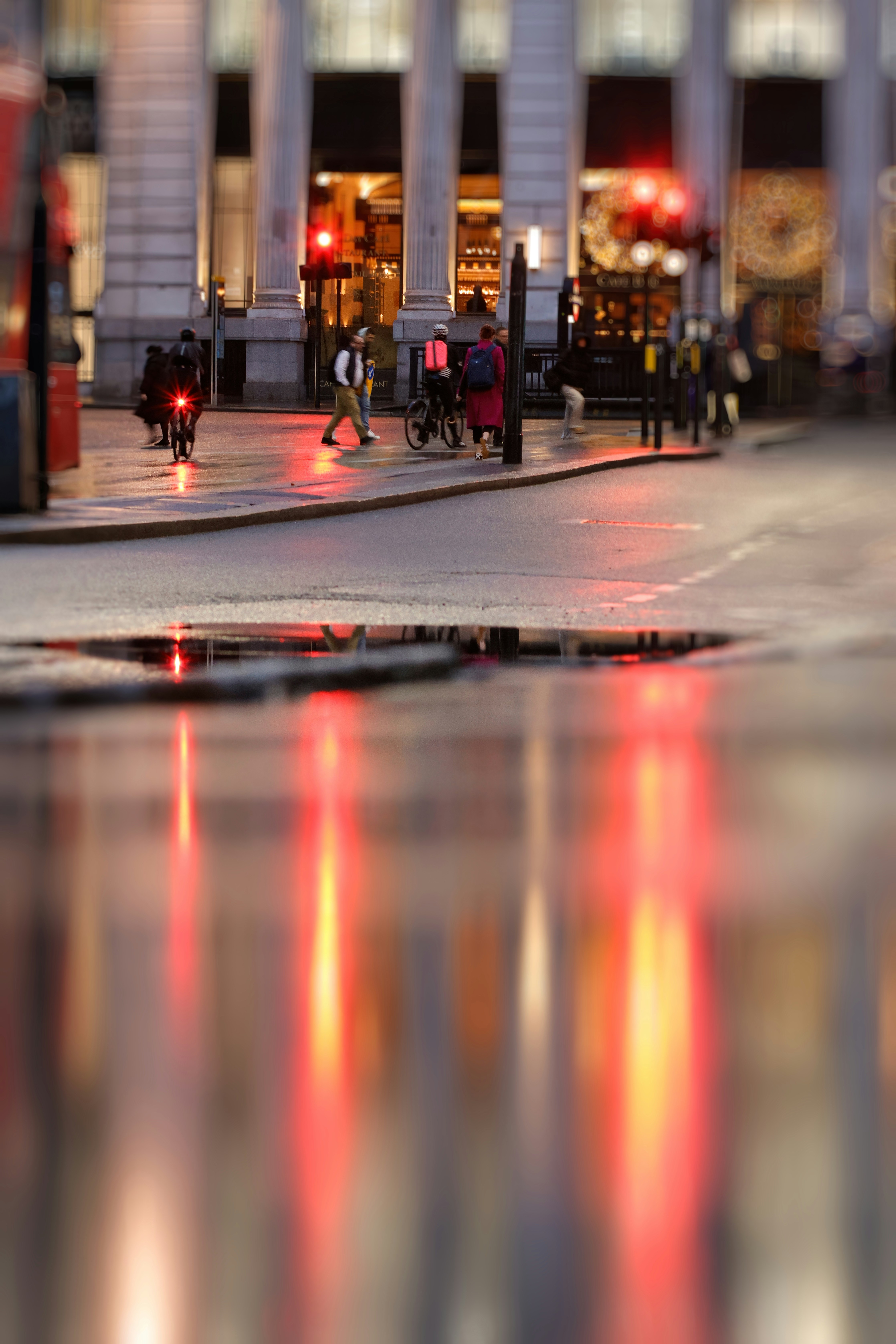 City street reflections after rain at dusk.