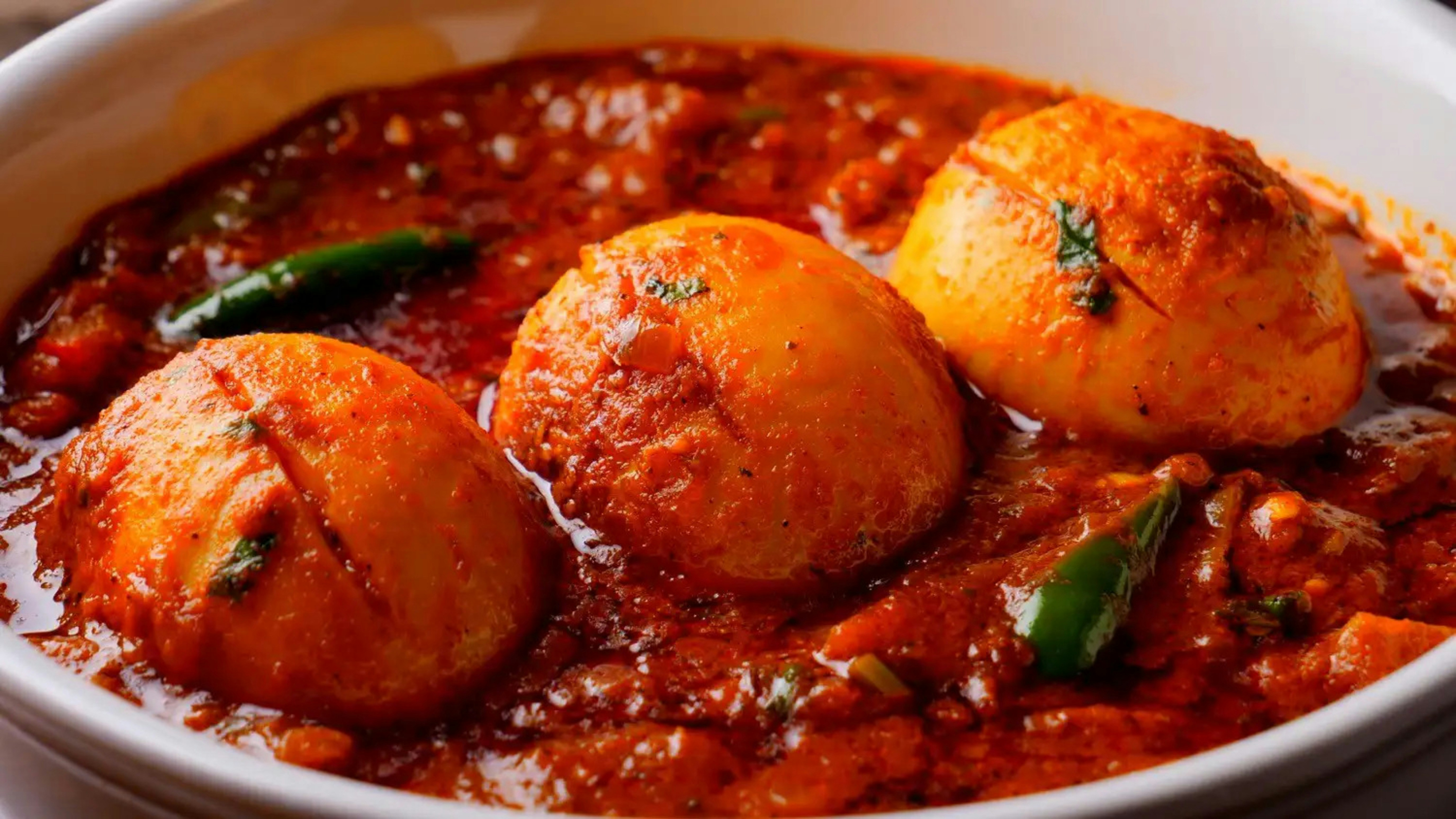 Three eggs in a rich, spicy indian curry