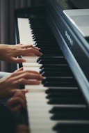 Hands playing a kawai digital piano