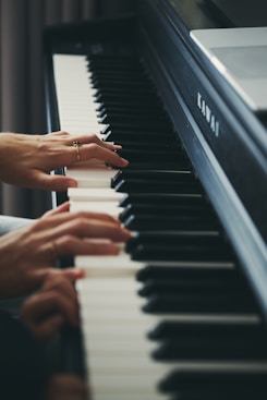 Hands playing a kawai digital piano