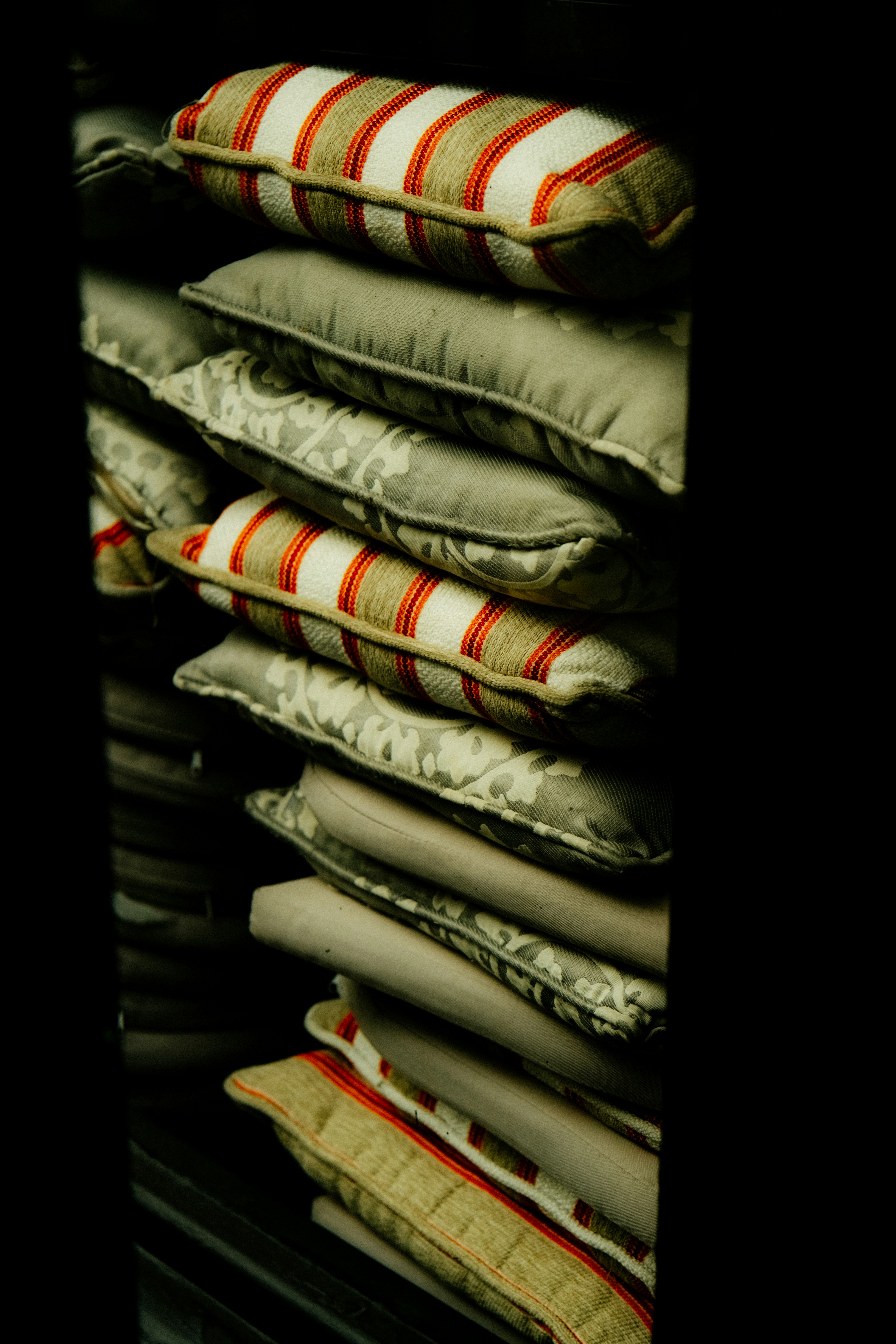 Stack of decorative pillows with striped patterns.