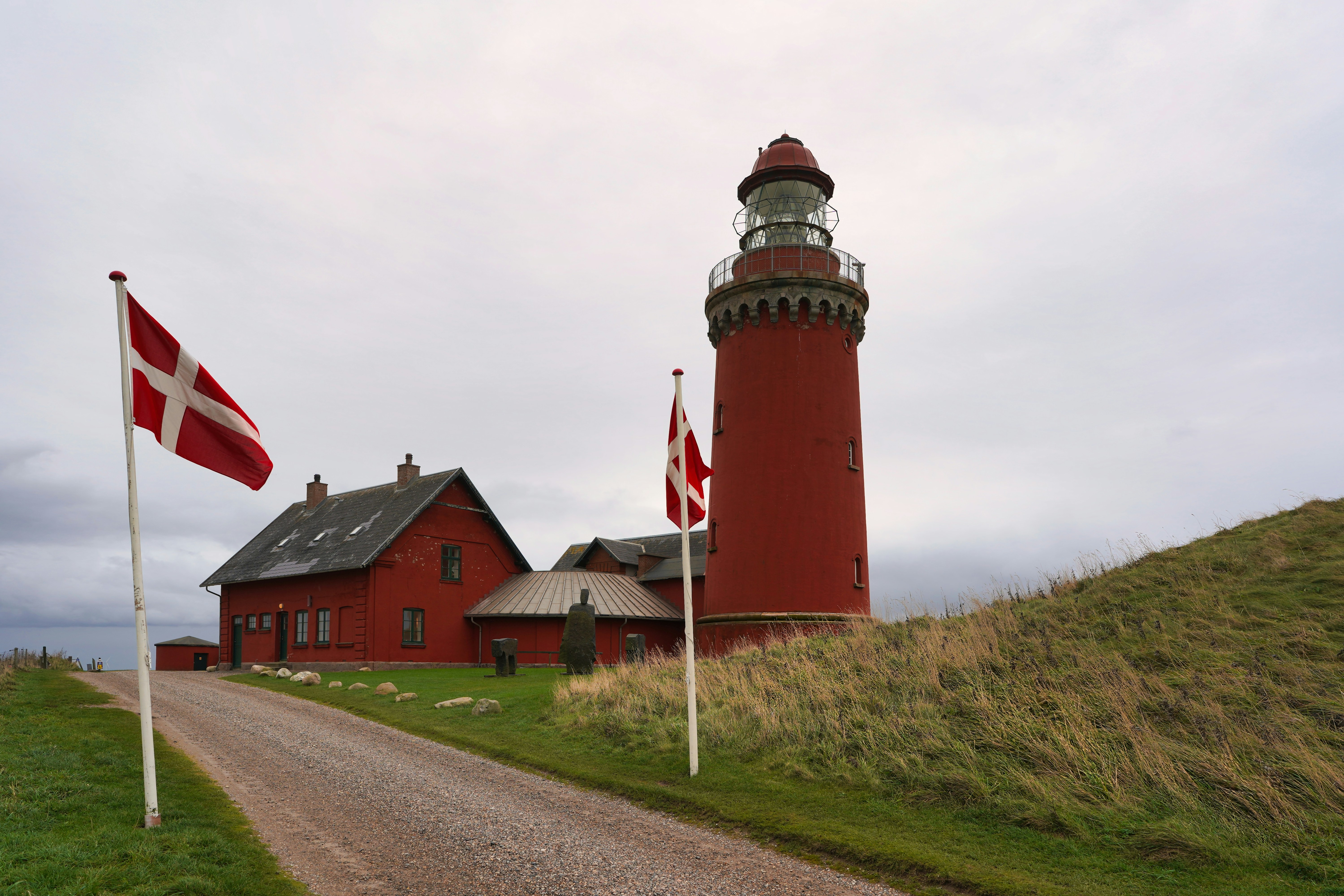Red lighthouse and buildings with danish flags