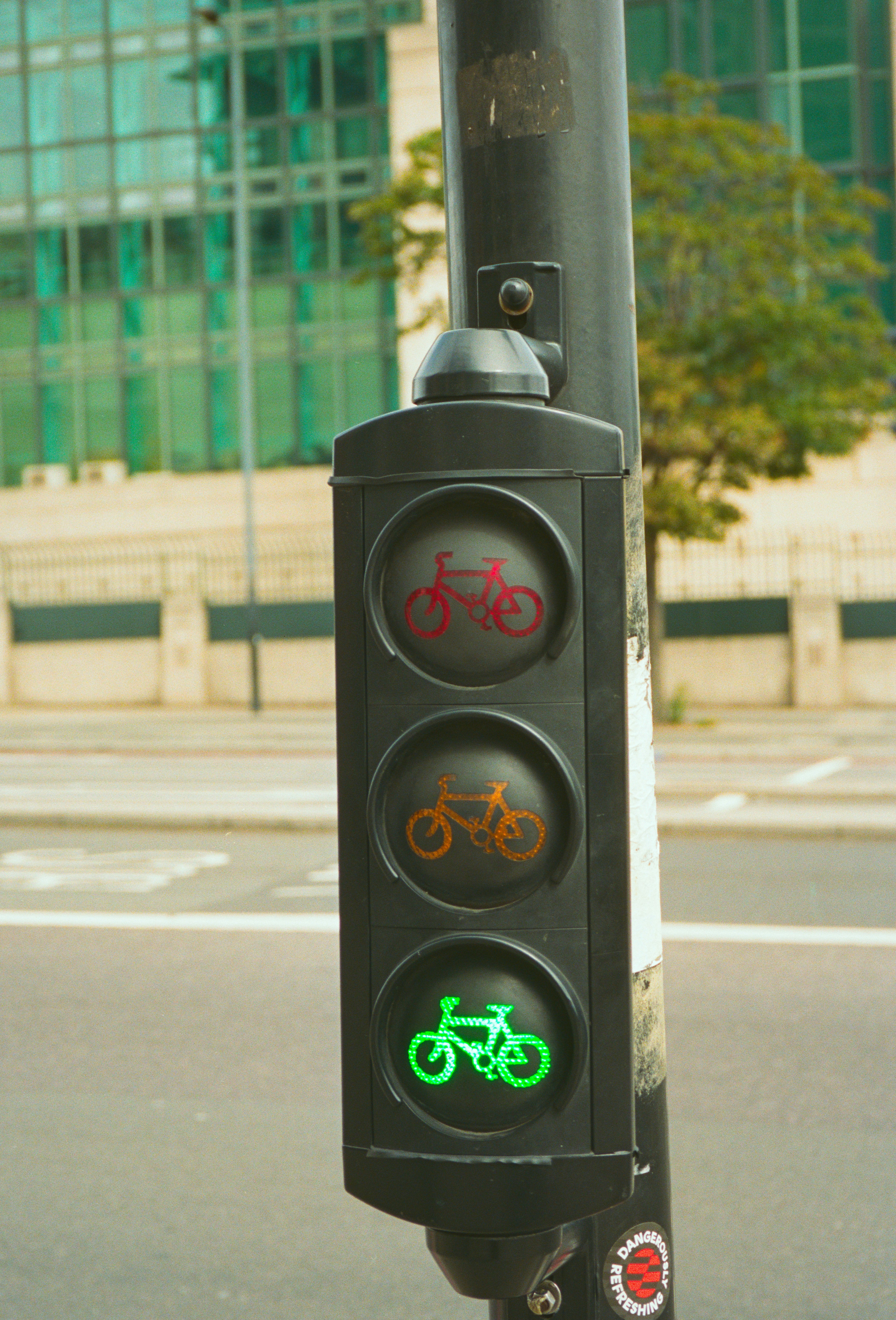 A traffic light for bicycles shows red, amber, and green.