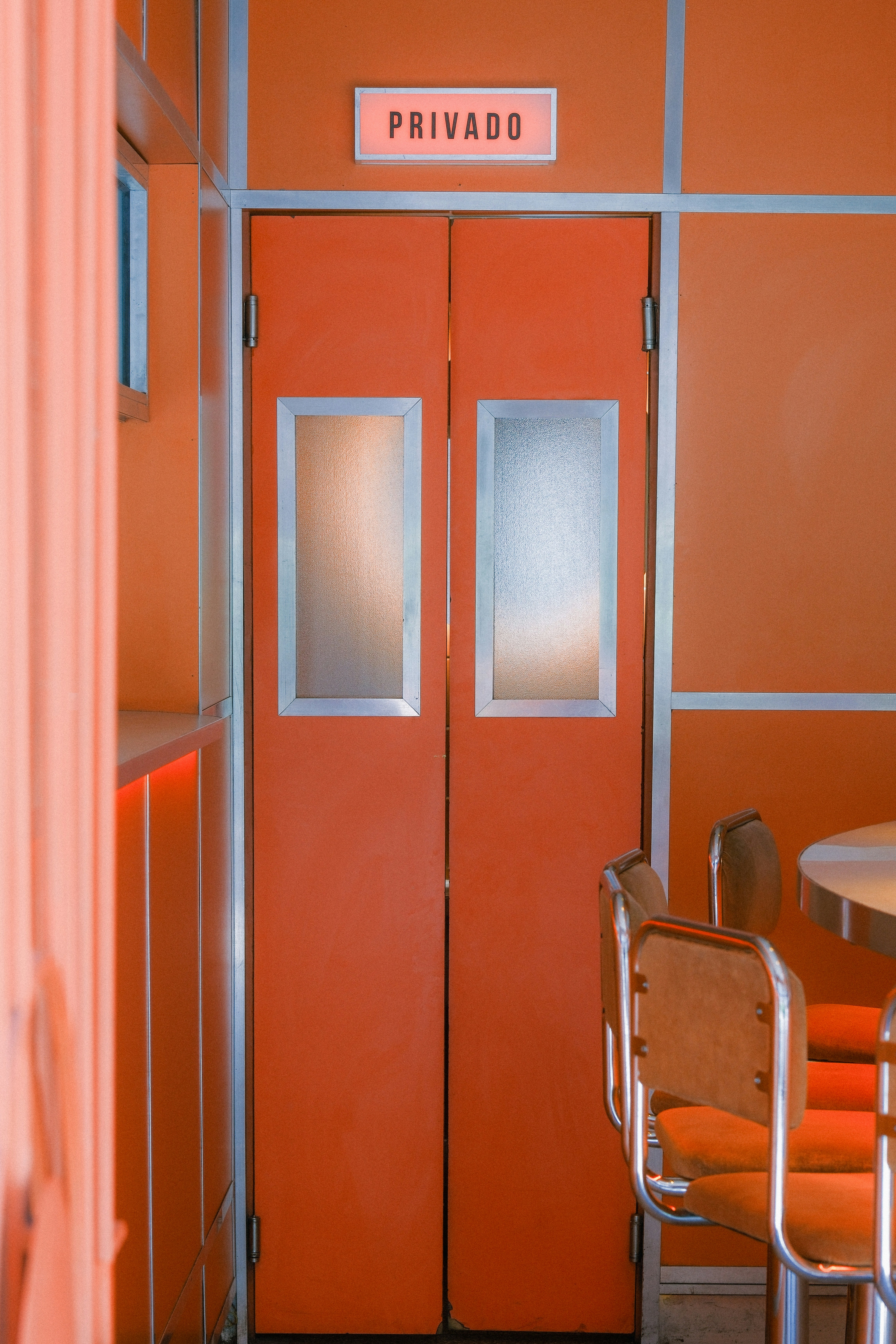 Orange doors with 'privado' sign above