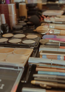 Assortment of makeup brushes and cosmetics on a table