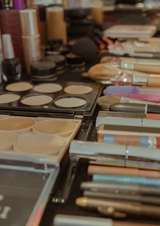 Assortment of makeup brushes and cosmetics on a table
