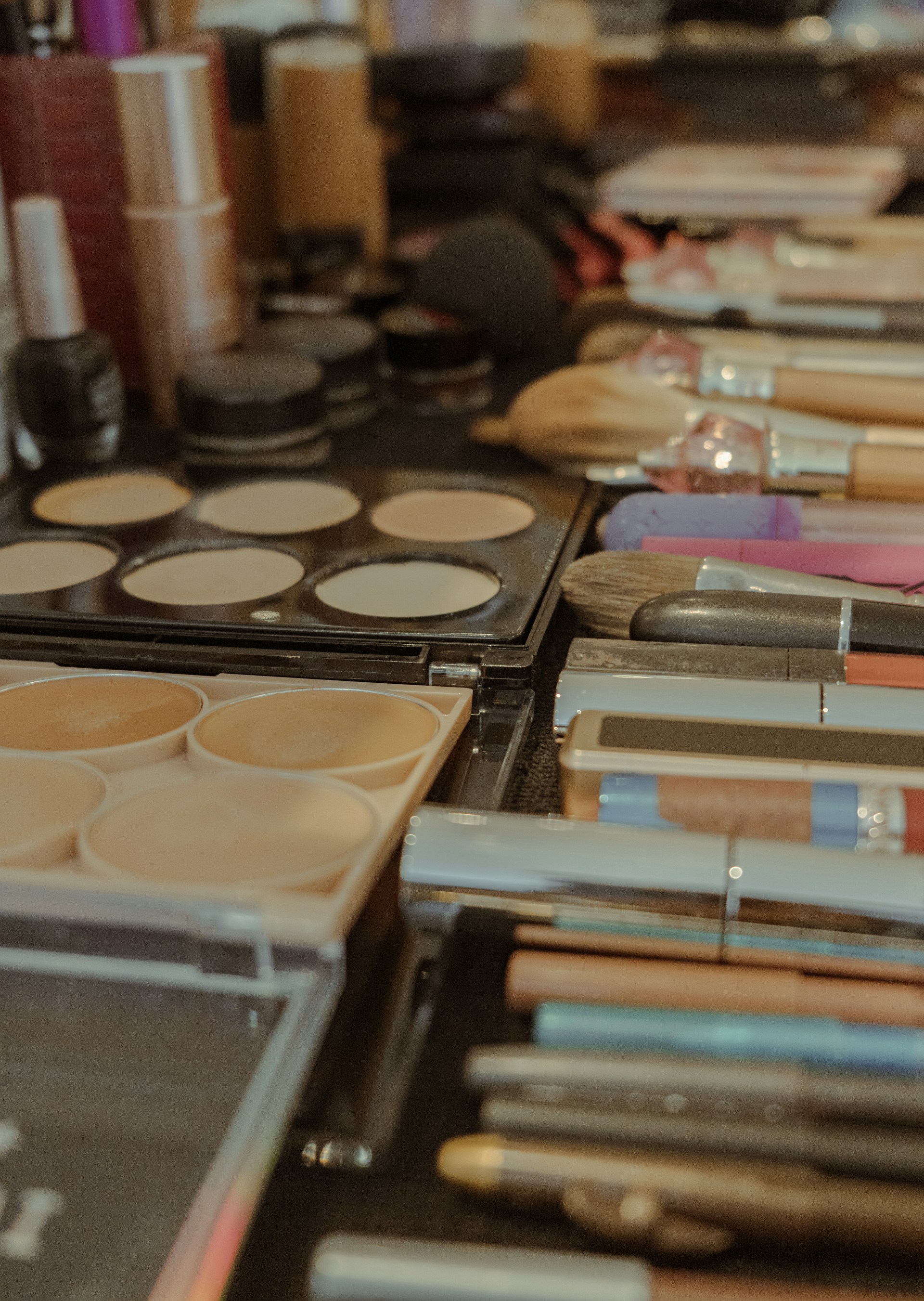 Assortment of makeup brushes and cosmetics on a table