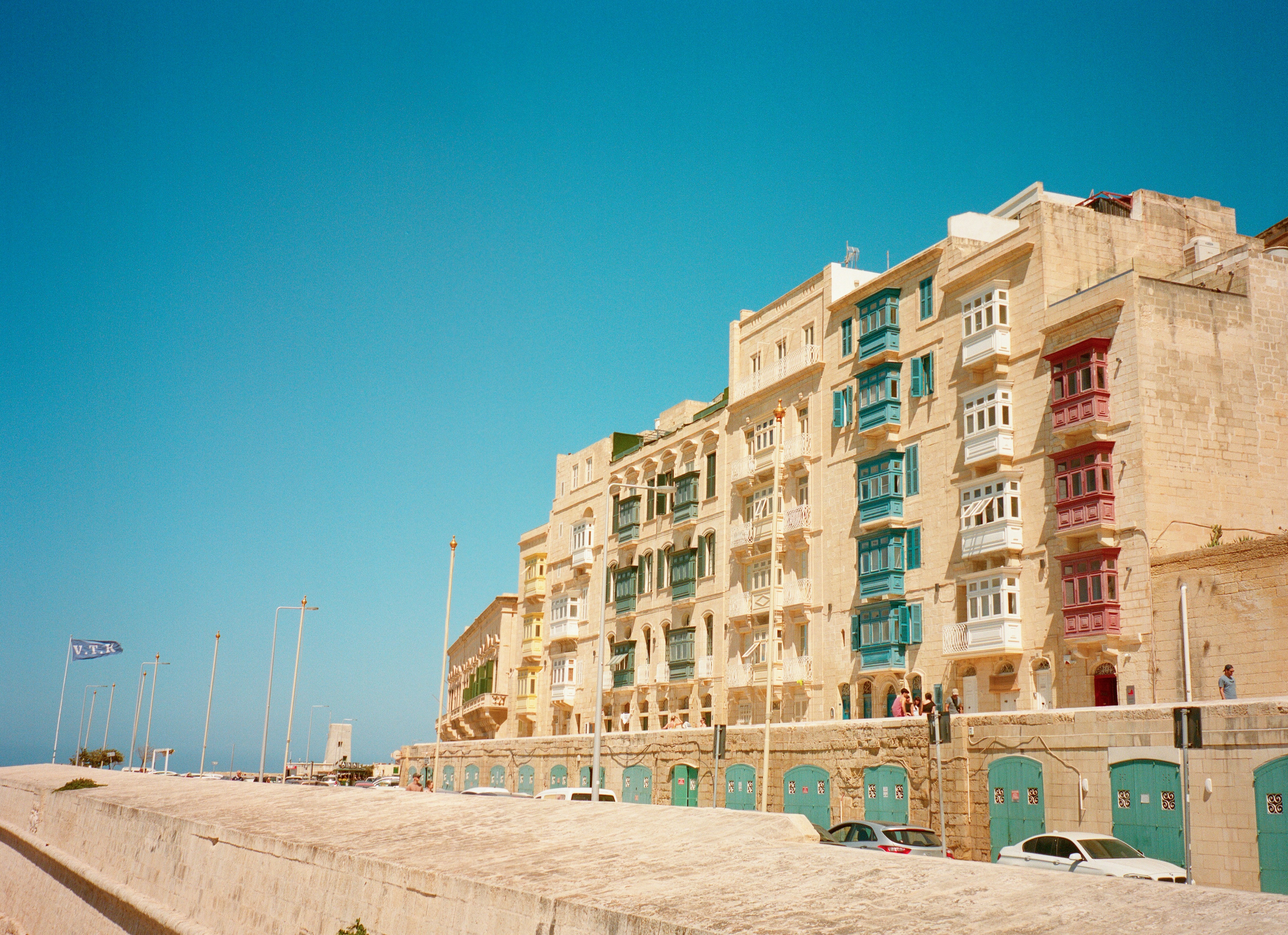 Yellow buildings with colorful balconies under blue sky