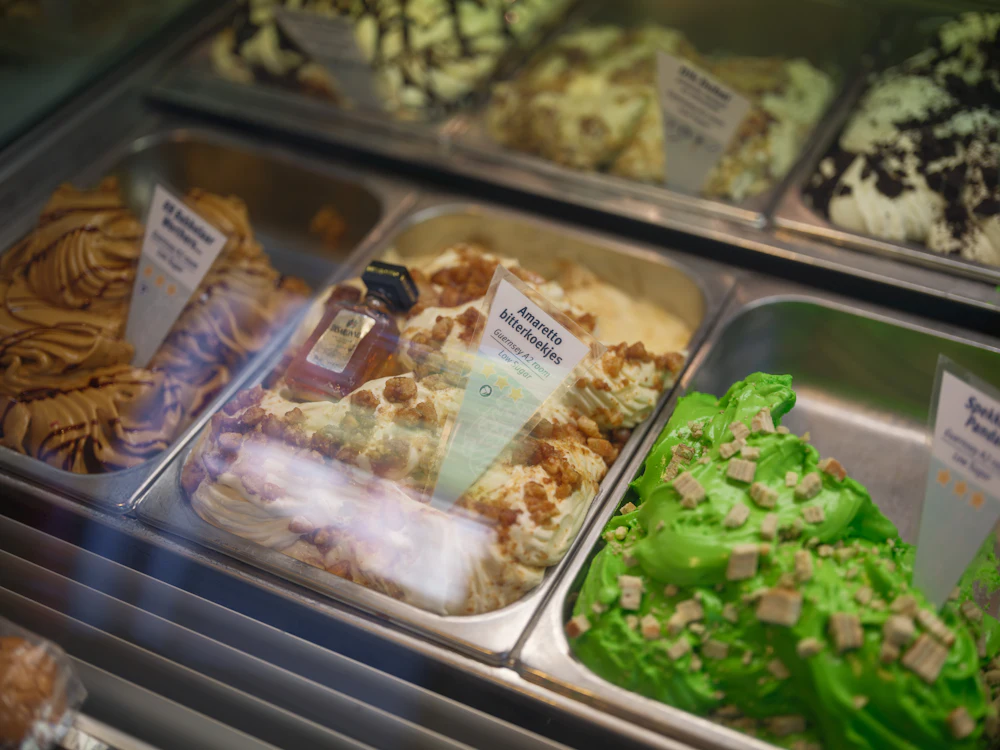 Trays of gelato in a display case, each labelled