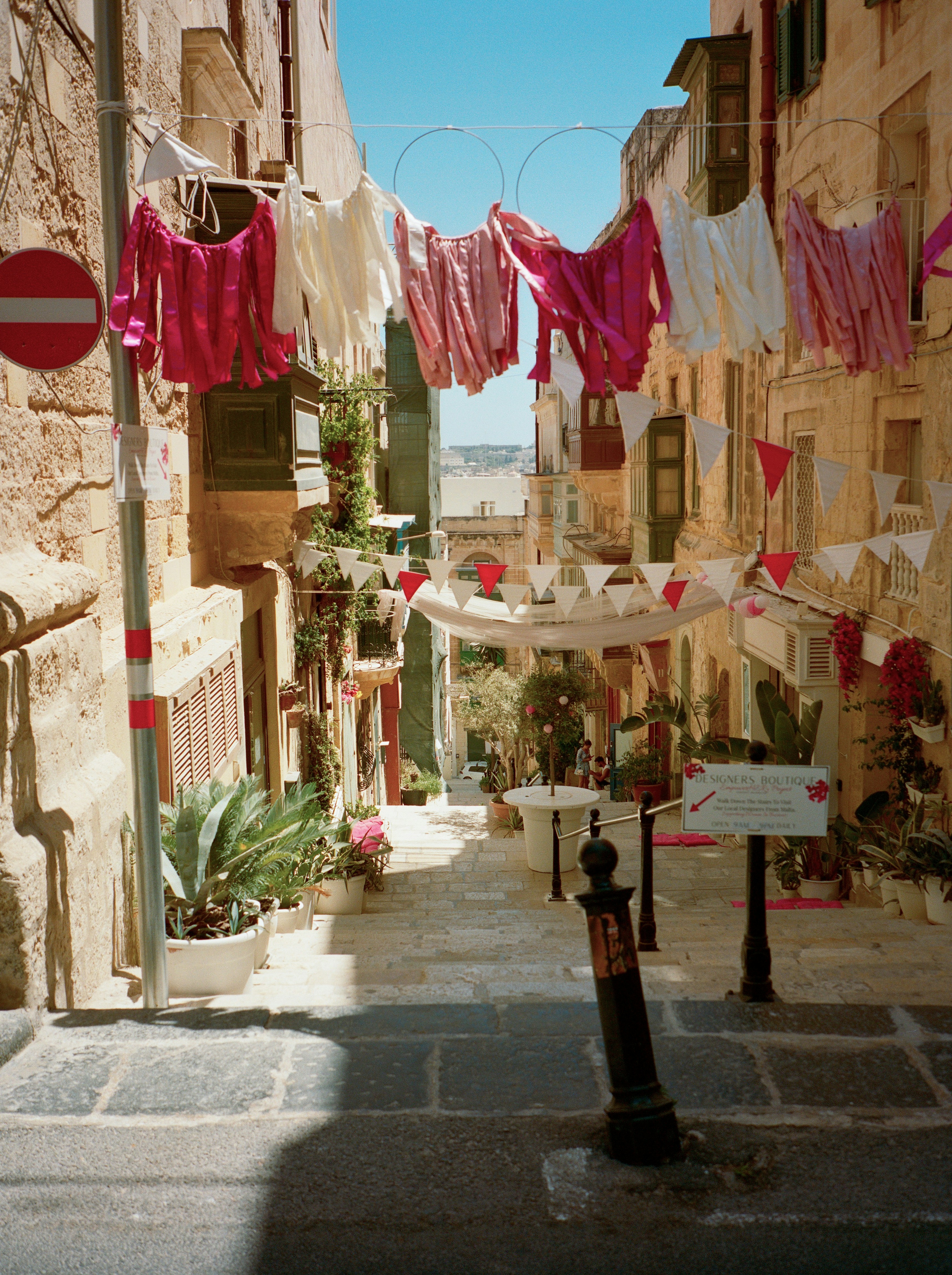 Laundry hangs across a narrow european street.