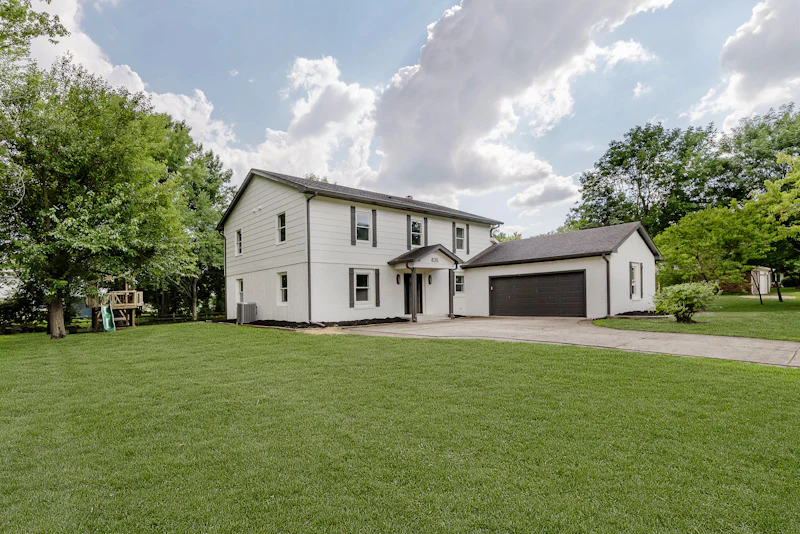 White two-storey home with an attached garage in Coldstream