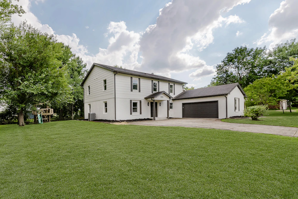 A white two-storey house with an attached double garage