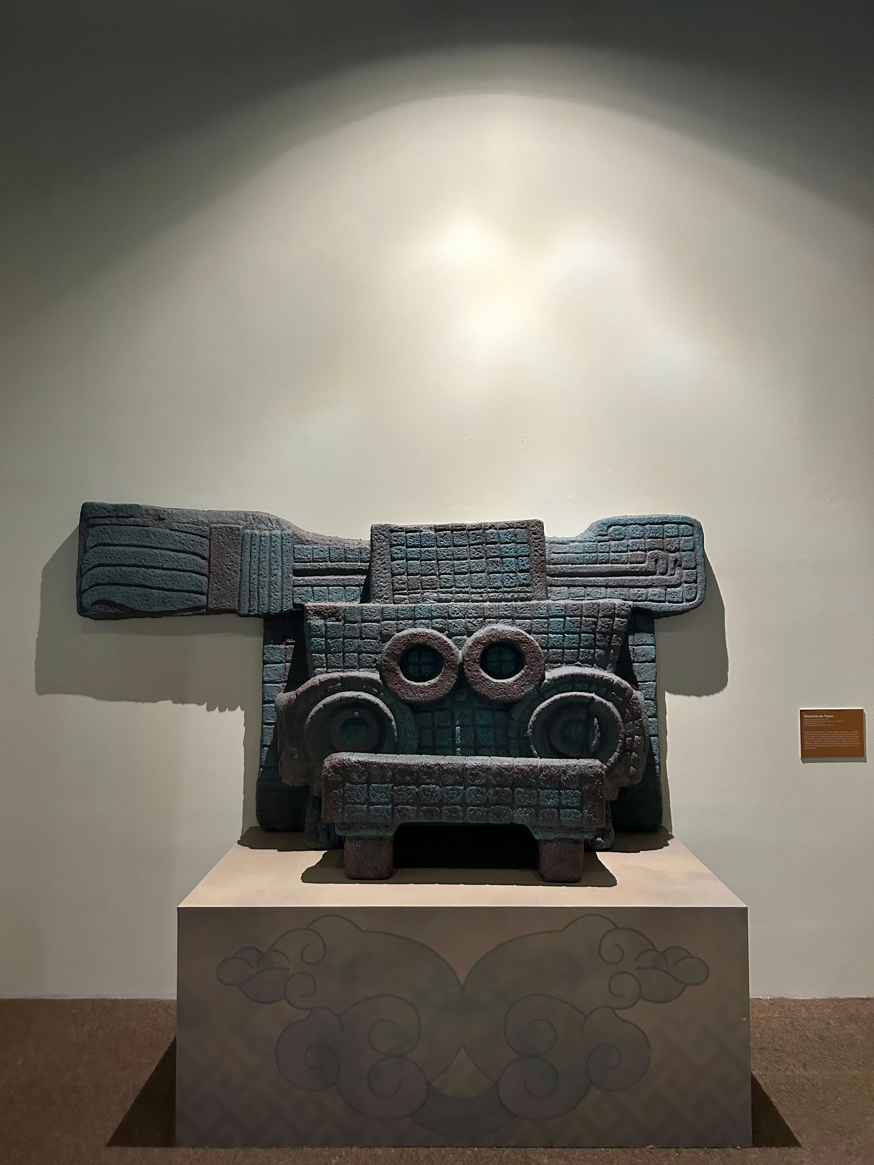 Ancient stone sculpture with intricate carvings on display