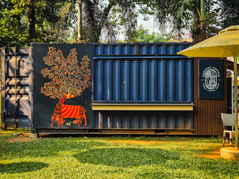 Shipping container converted into a kiosk with mural