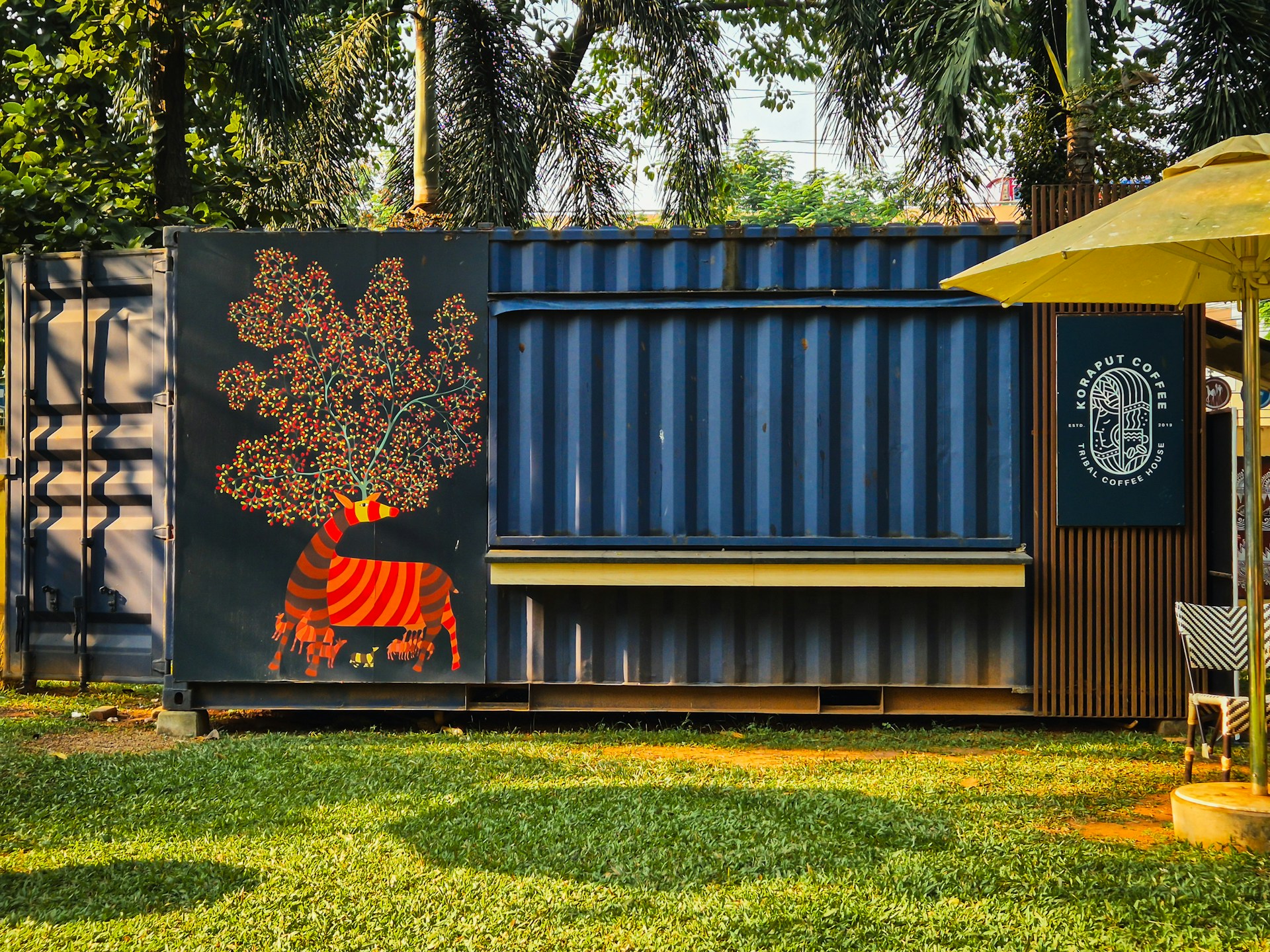Shipping container converted into a kiosk with mural