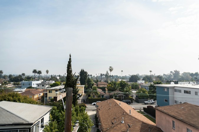 Suburban neighborhood with single story homes and palm trees, similar to residential streets across the Las Vegas valley