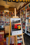 Poster on easel in a bookstore with bookshelves