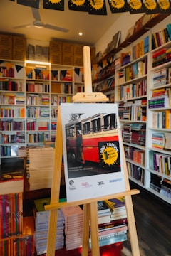 Poster on easel in a bookstore with bookshelves