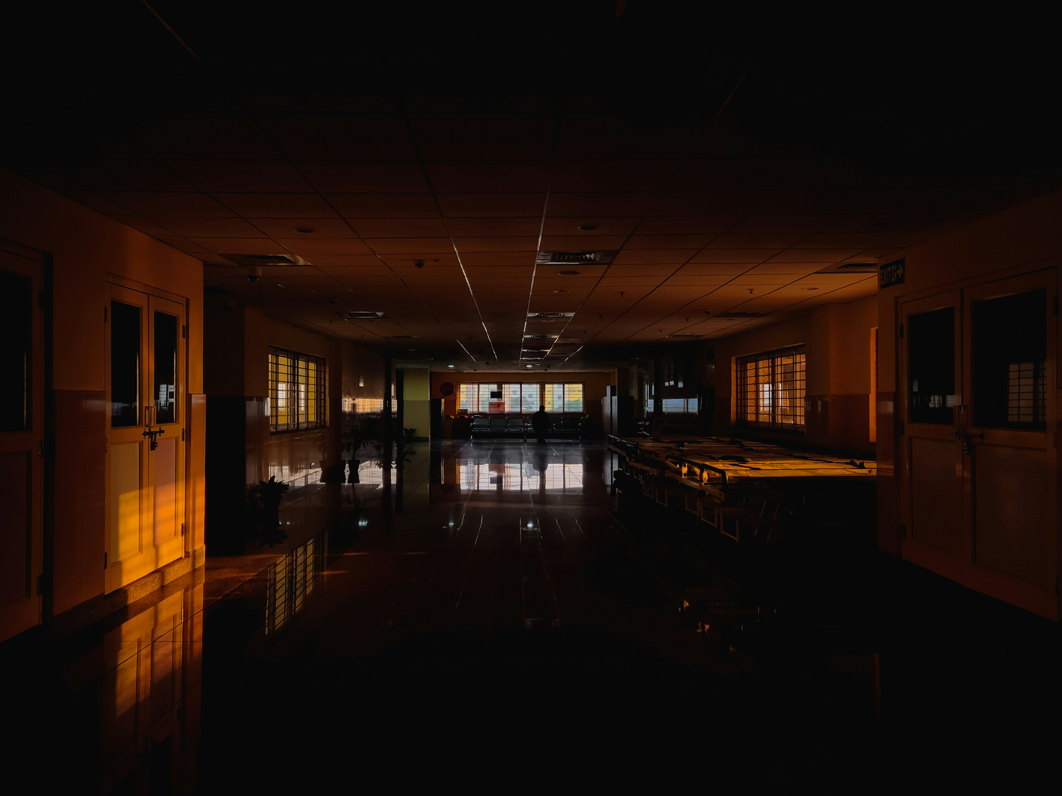 Dark hospital hallway with warm light