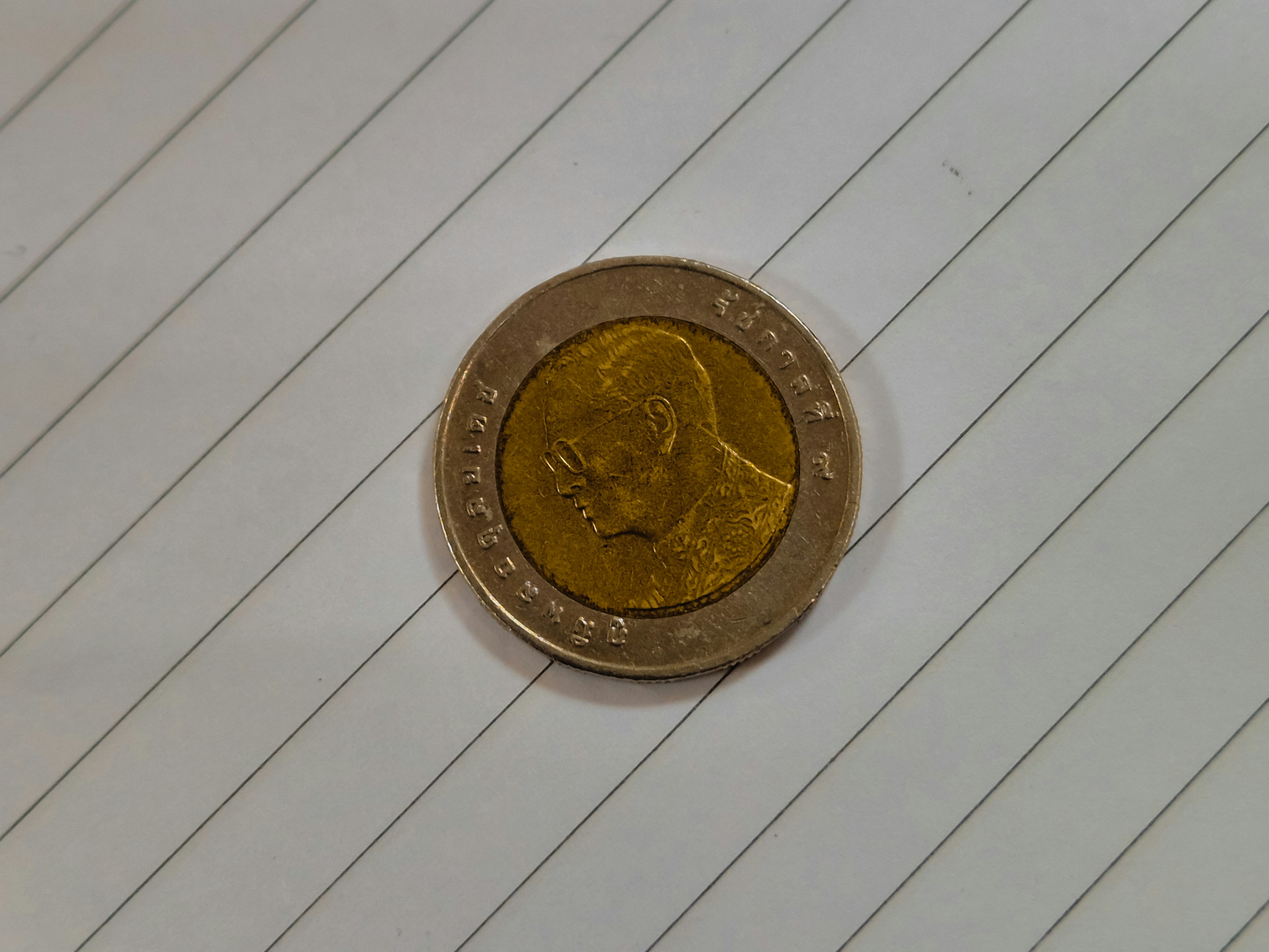 A close-up of a coin with a profile