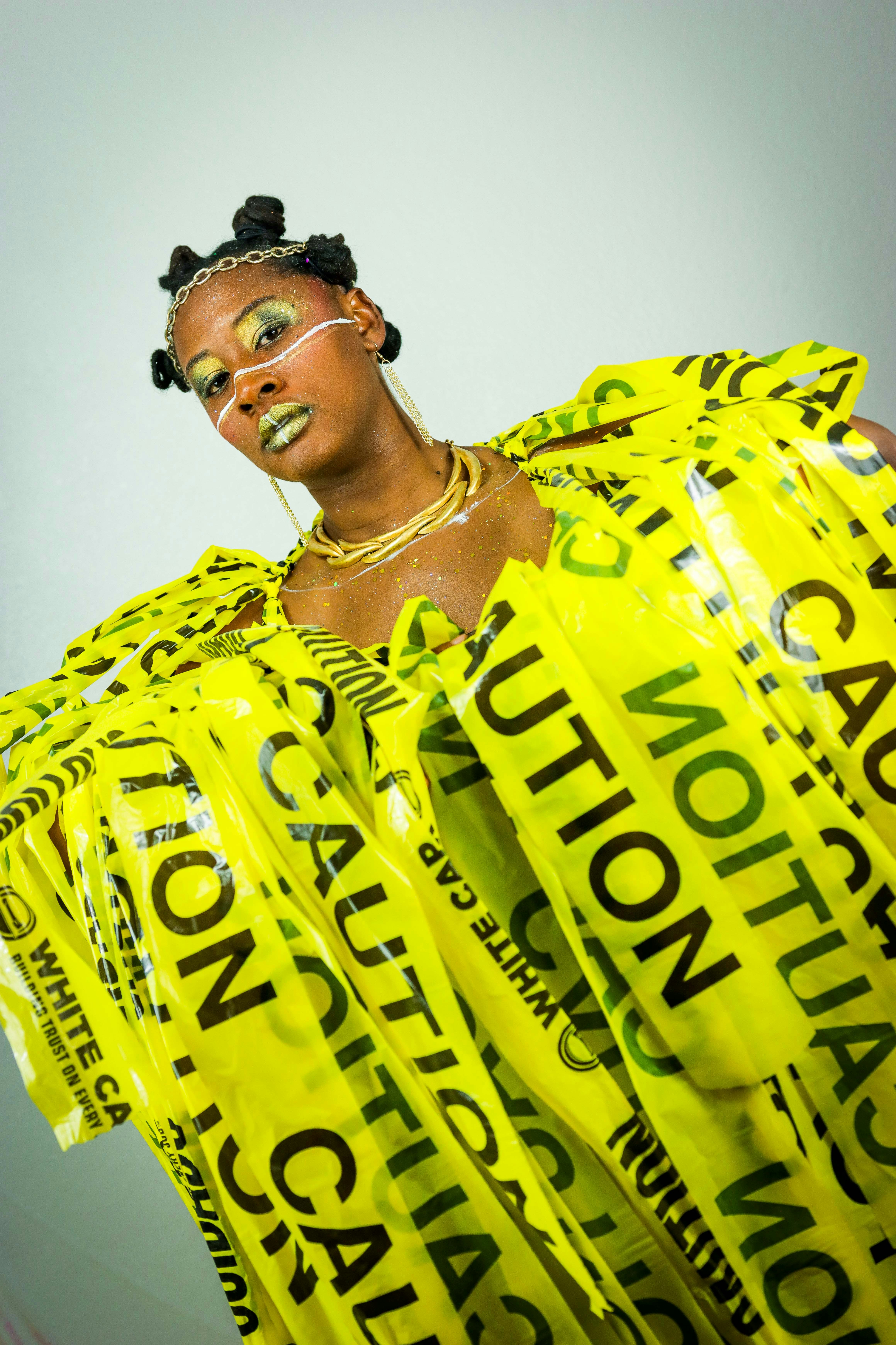 Woman wears a dress made of caution tape