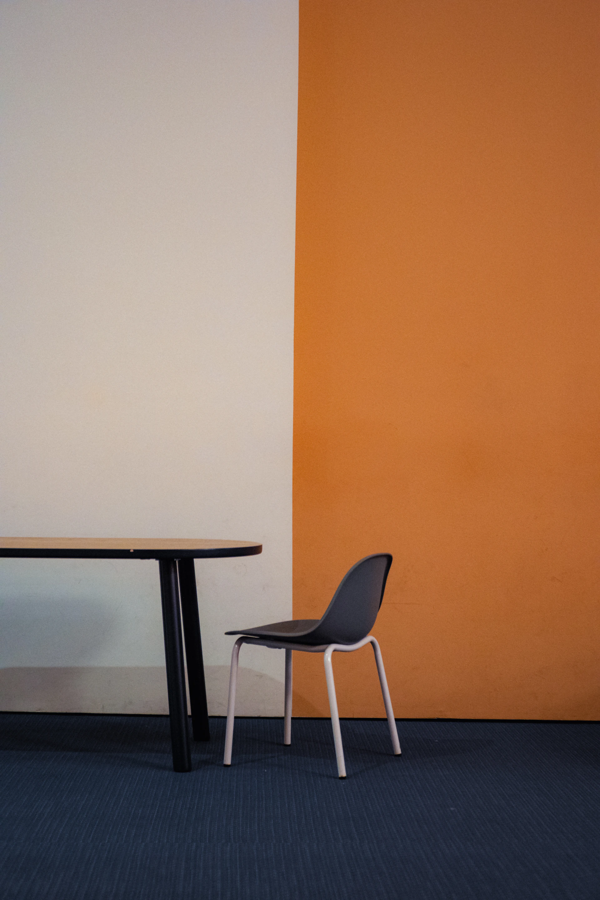 A chair and table against a two-toned wall