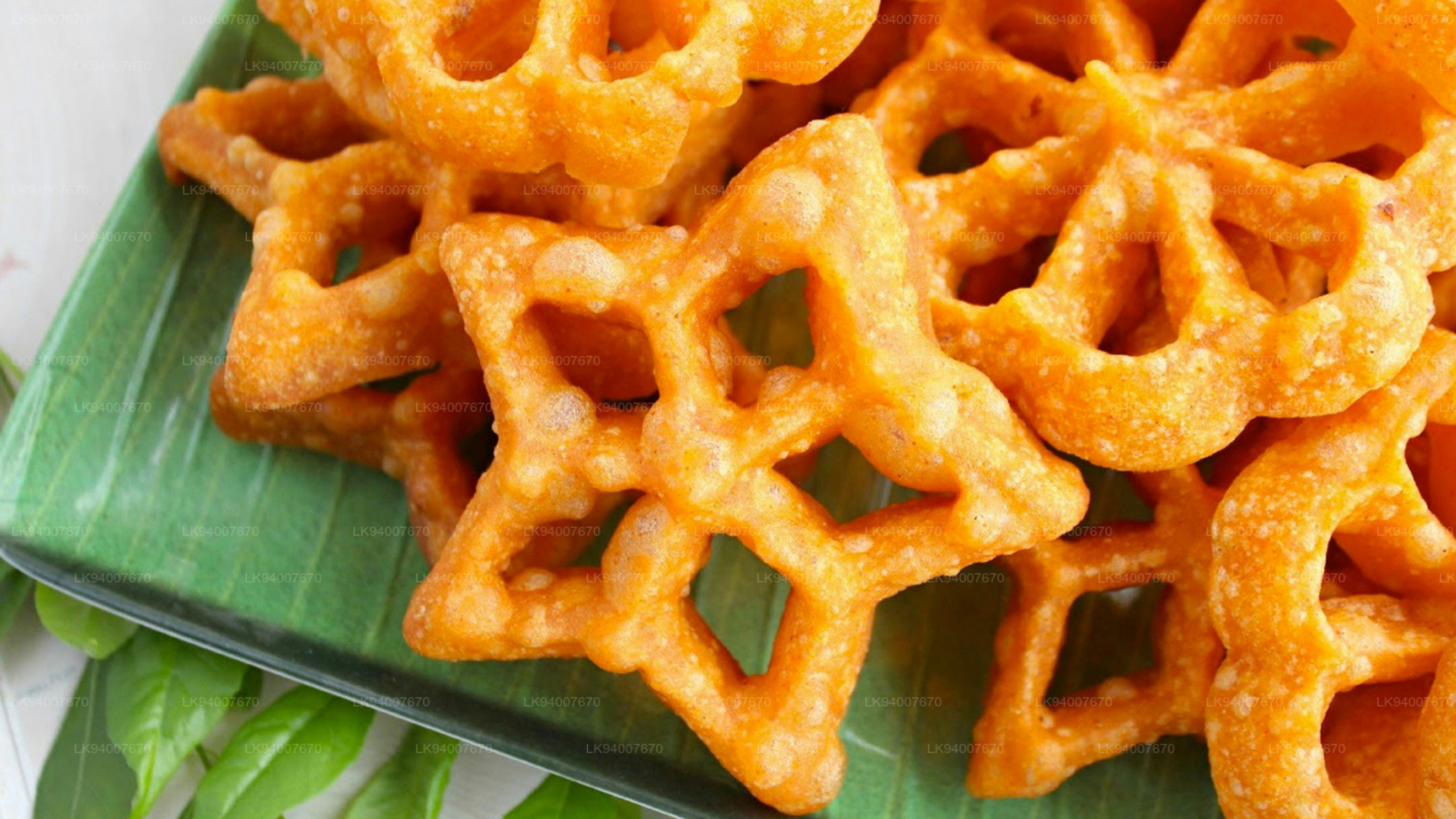 Golden star-shaped fried pastries on a green plate