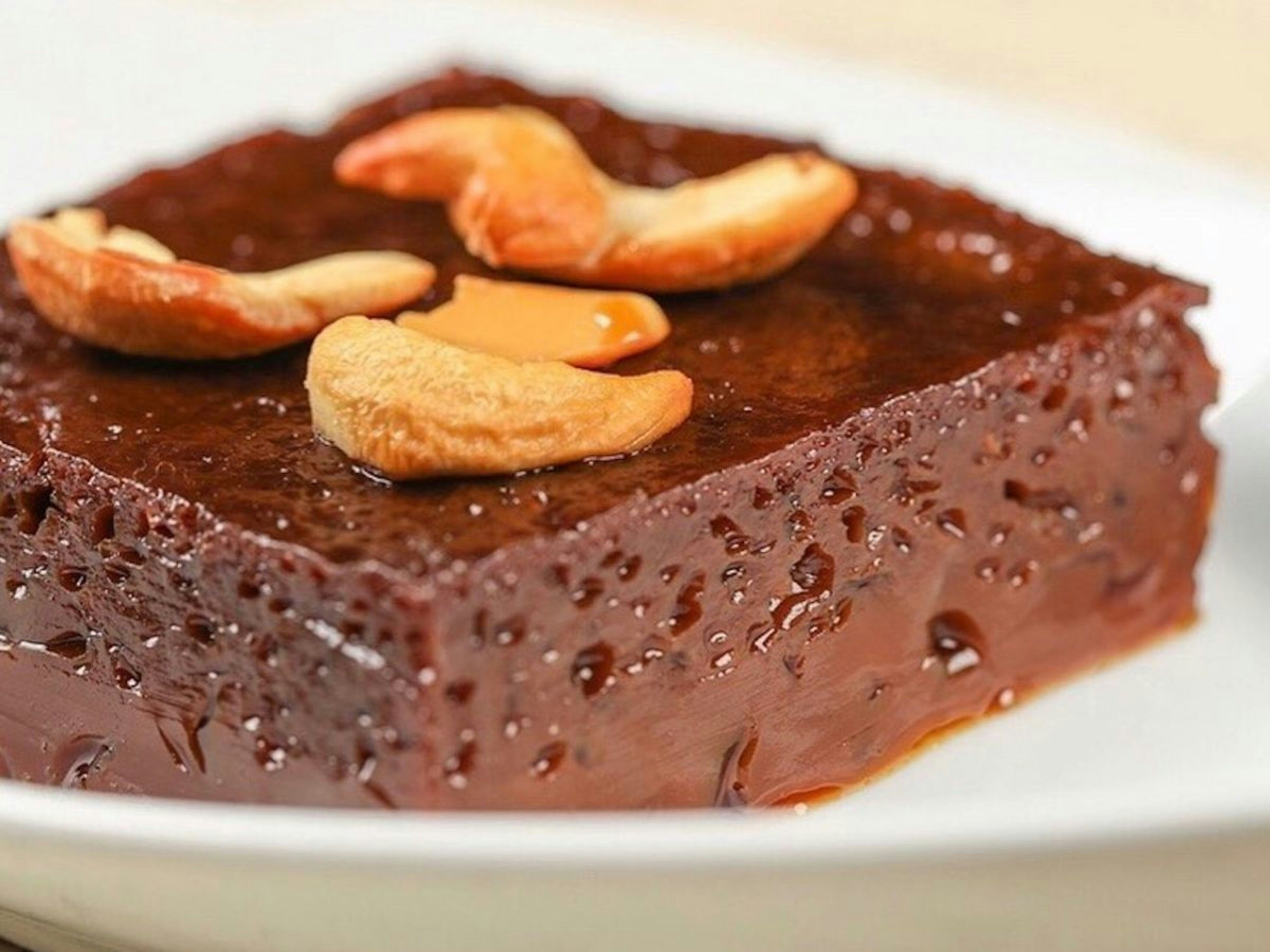 A rich chocolate dessert topped with cashews