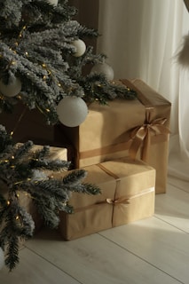 Christmas tree with gifts wrapped in brown paper.