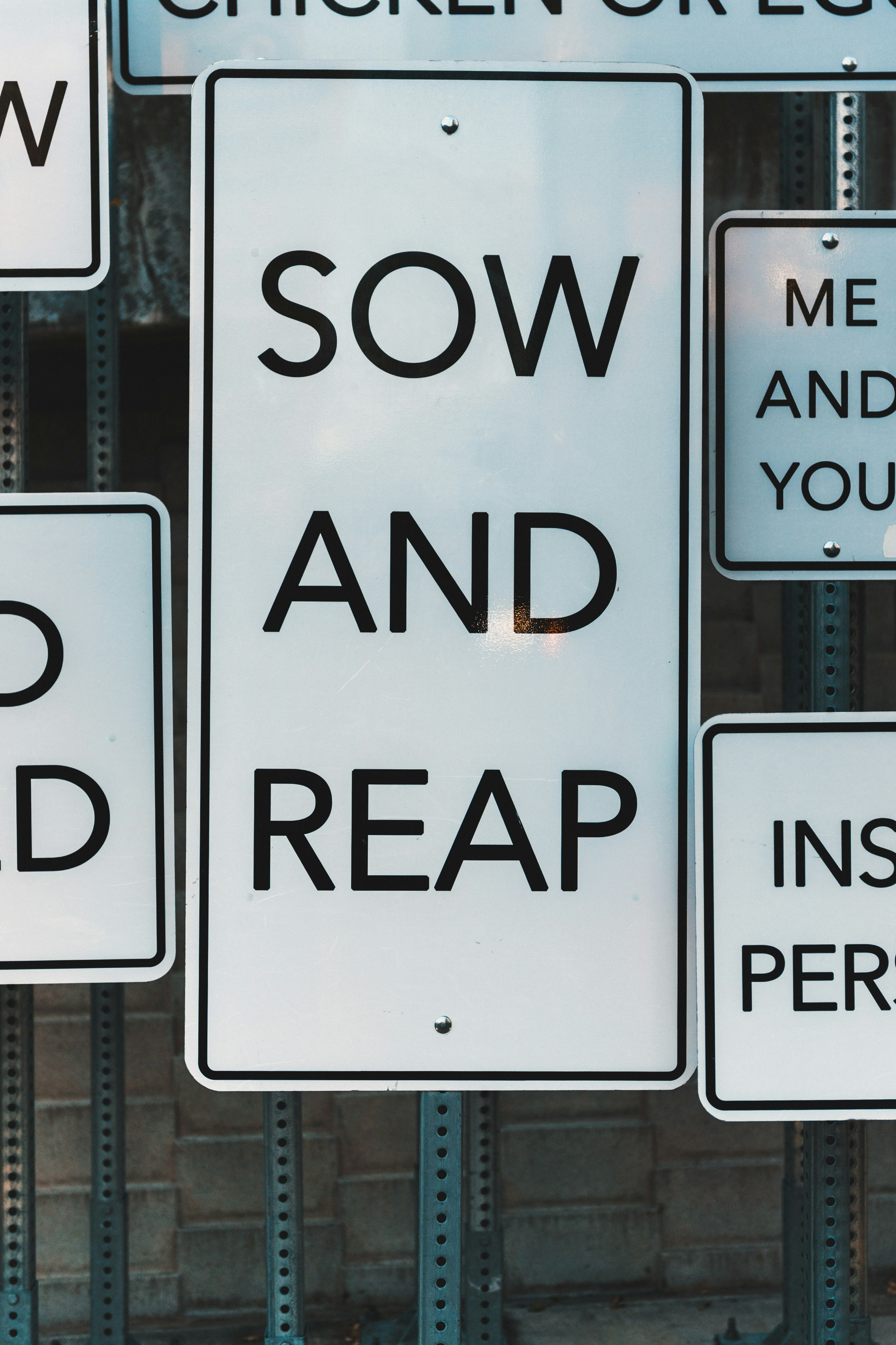 Sow and reap on white signs