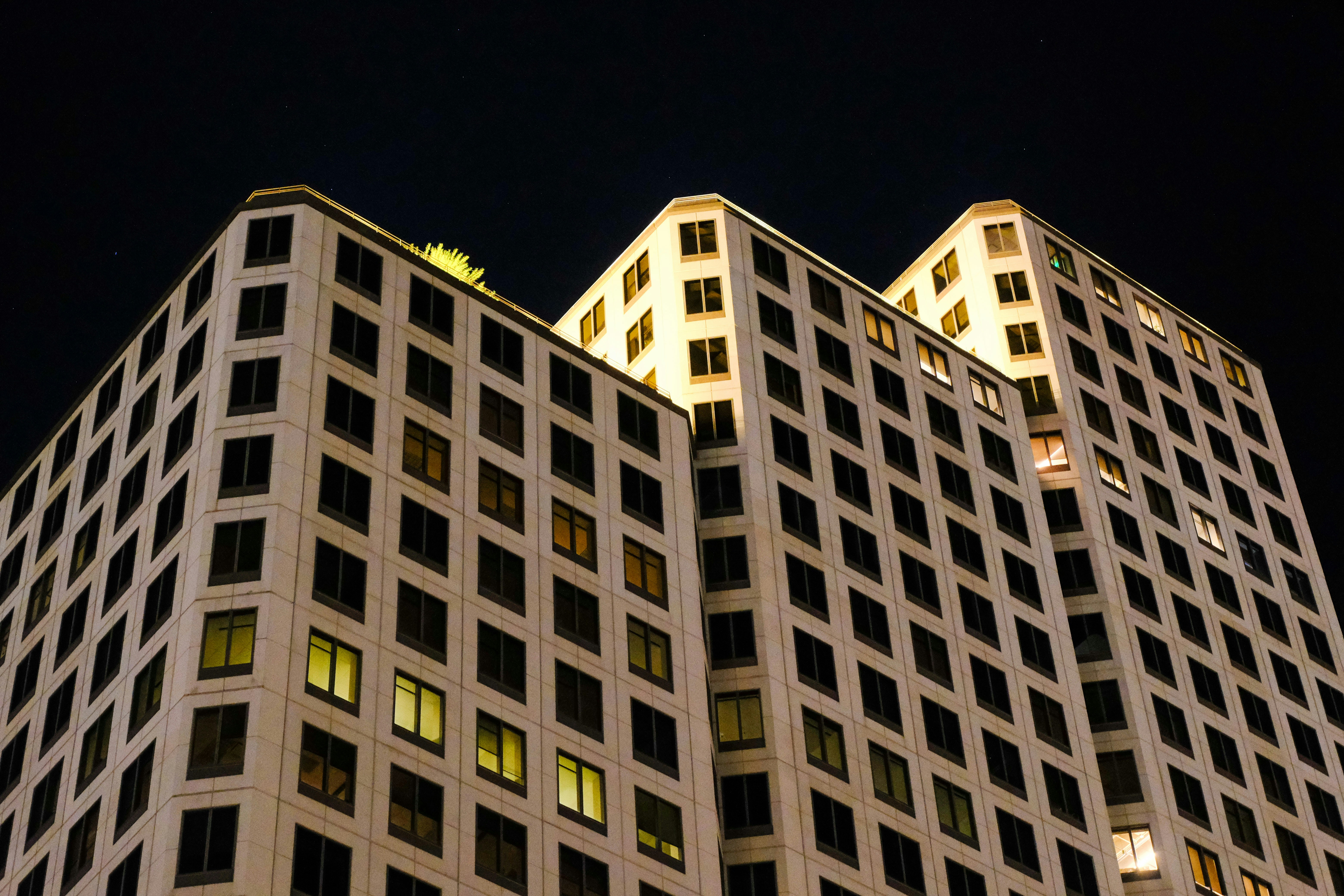 Tall modern building illuminated at night