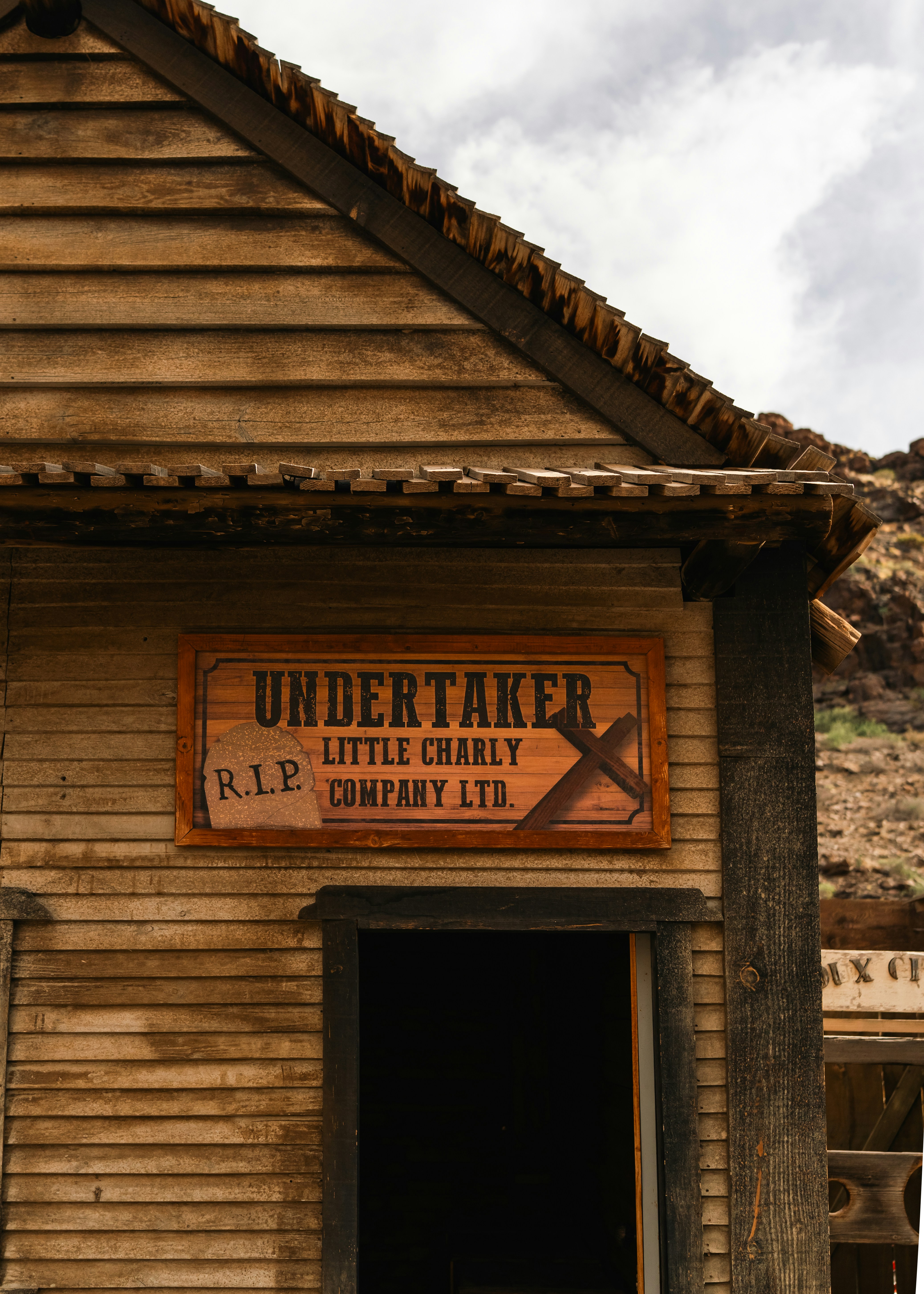 Undertaker company sign on wooden building